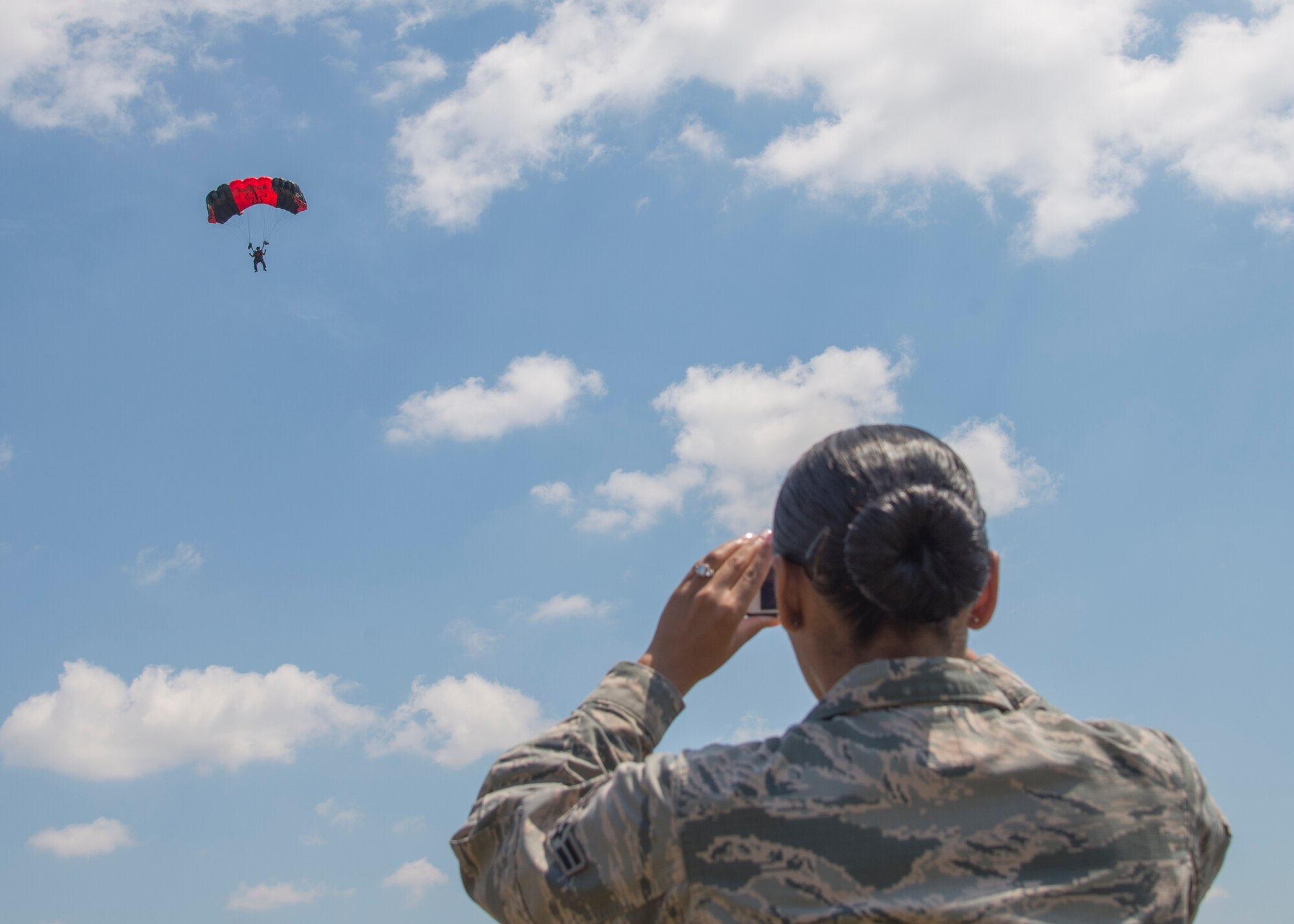 Members of the Black Daggers, the official U.S. Army Special Operations Command Parachute Demonstration Team, perform aerial stunts during Scott Air Force Base 2017 Air Show and Open House June 11, which celebrates the base’s 100th anniversary.  Black Daggers are highly trained Soldiers who insert themselves behind enemy lines to disrupt the movement of enemy troops and supplies to the front lines.  They frequently use parachutes to infiltrate without being detected. (Air Force photo by Airman 1st Class Daniel Garcia)