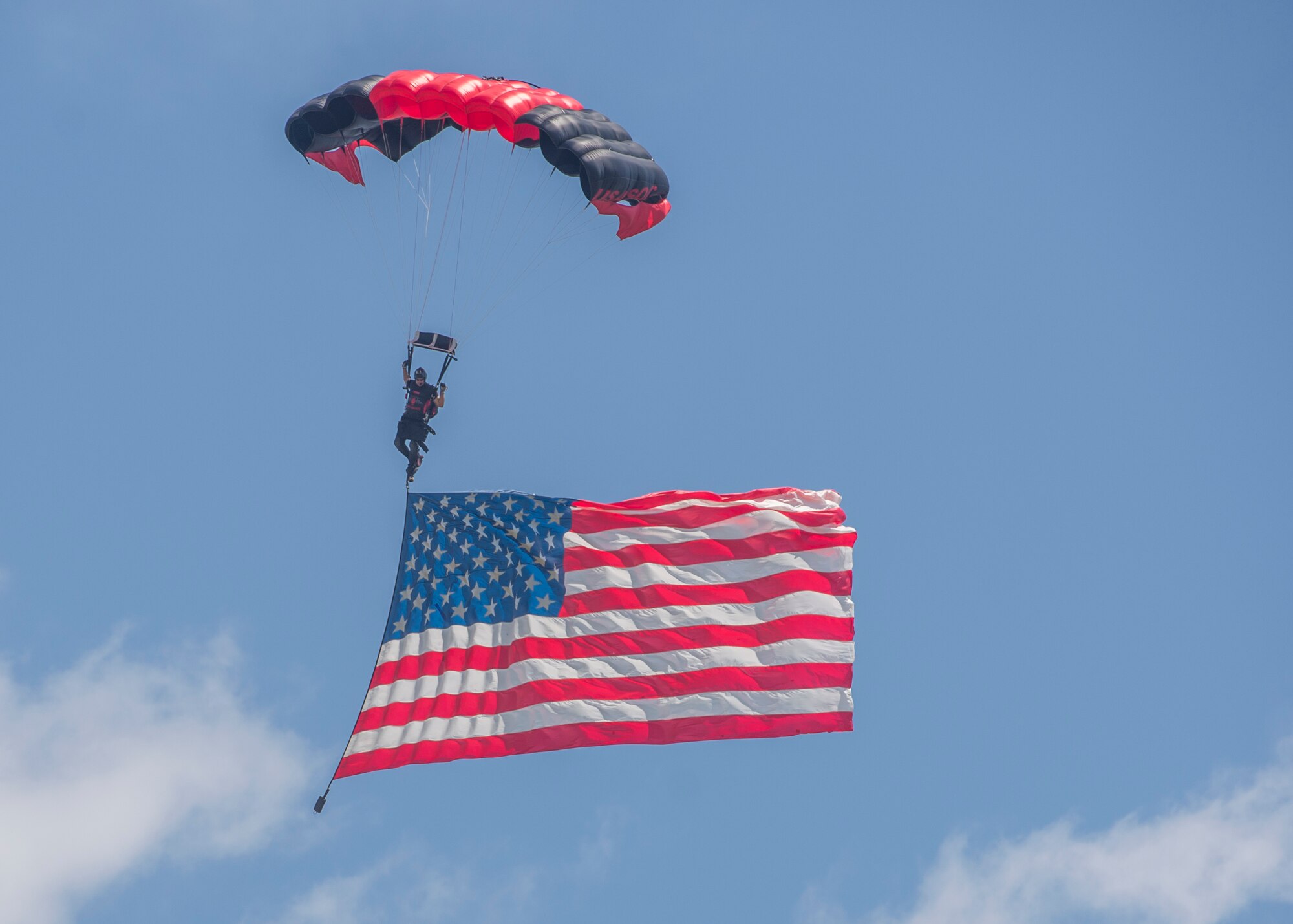 Members of the Black Daggers, the official U.S. Army Special Operations Command Parachute Demonstration Team, perform aerial stunts during Scott Air Force Base 2017 Air Show and Open House June 11, which celebrates the base’s 100th anniversary.  Black Daggers are highly trained Soldiers who insert themselves behind enemy lines to disrupt the movement of enemy troops and supplies to the front lines.  They frequently use parachutes to infiltrate without being detected. (Air Force photo by Airman 1st Class Daniel Garcia)