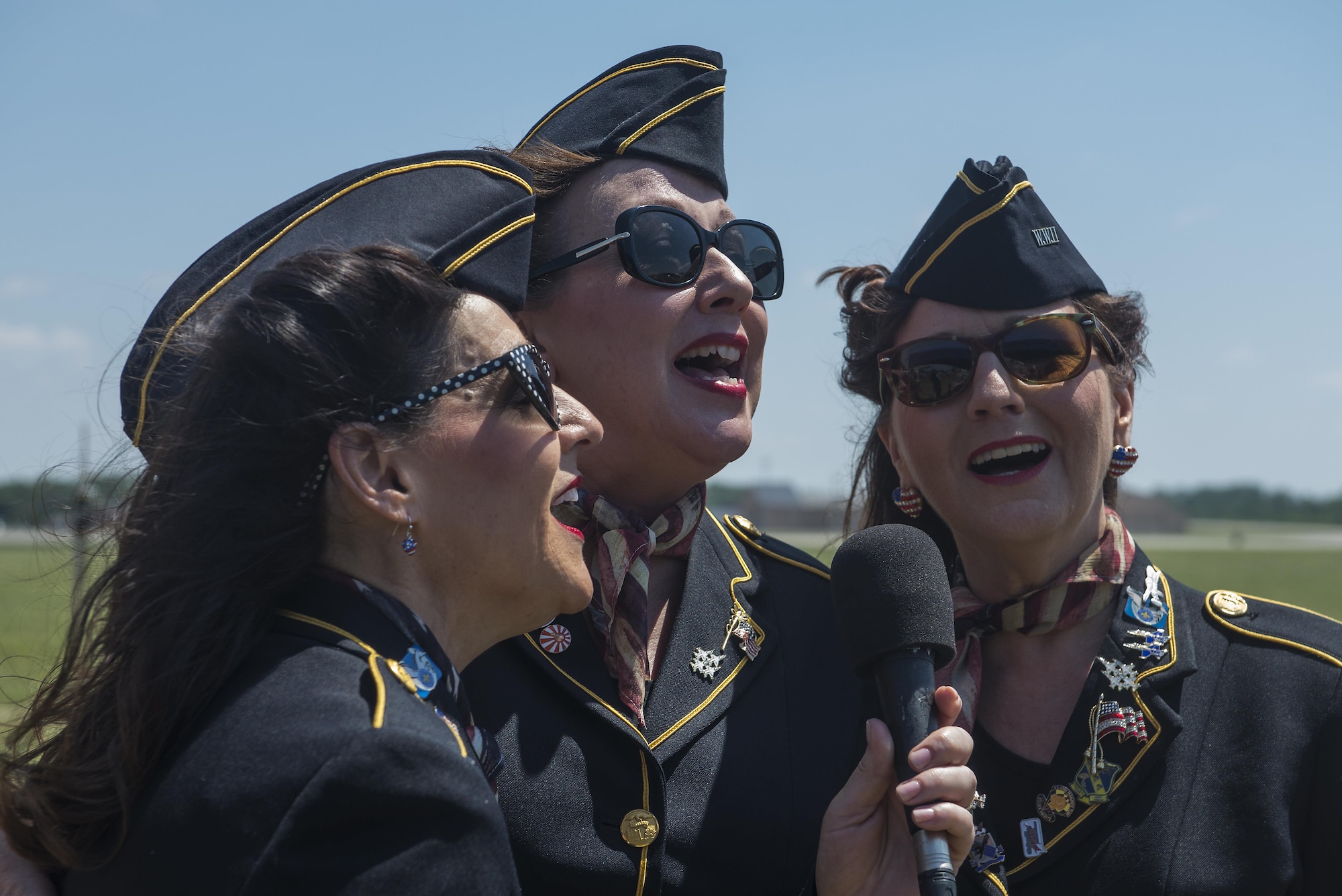 The Ladies for Liberty perform the national anthem during the Scott Airshow and Open House at Scott Air Force Base, Ill., June 11, 2017. Ladies for Liberty is a singing troupe dedicated to performing the Andrew Sisters style of music through their own rendition of vocals, costumes, hairstyles, and the spirit of patriotism reminiscent of the 1940s. (U.S. Air Force photo by Tech. Sgt. Jonathan Fowler)
