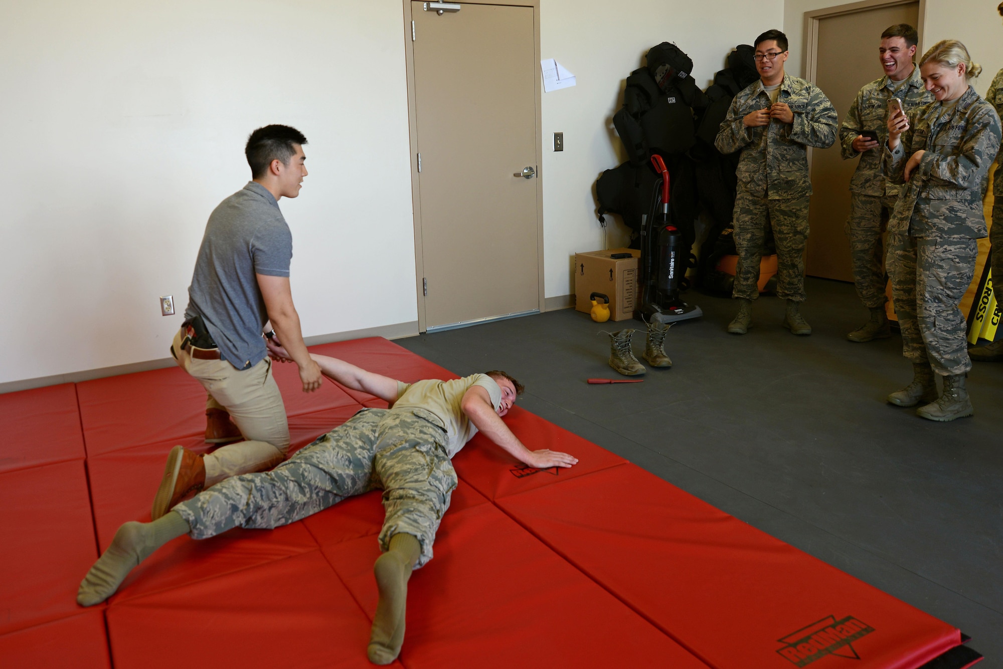 U.S. Air Force Special Agent James Min from the Office of Special Investigations Detachment 212 holds Cadet 2nd Class Parker Rosedahl, U.S. Air Force Academy cadet, on a mat at Shaw Air Force Base, S.C., June 9, 2017. Min demonstrated a take-down technique to cadets during their visit as part of the Operation Air Force program. (U.S. Air Force Airman 1st Class Kathryn R.C. Reaves)
