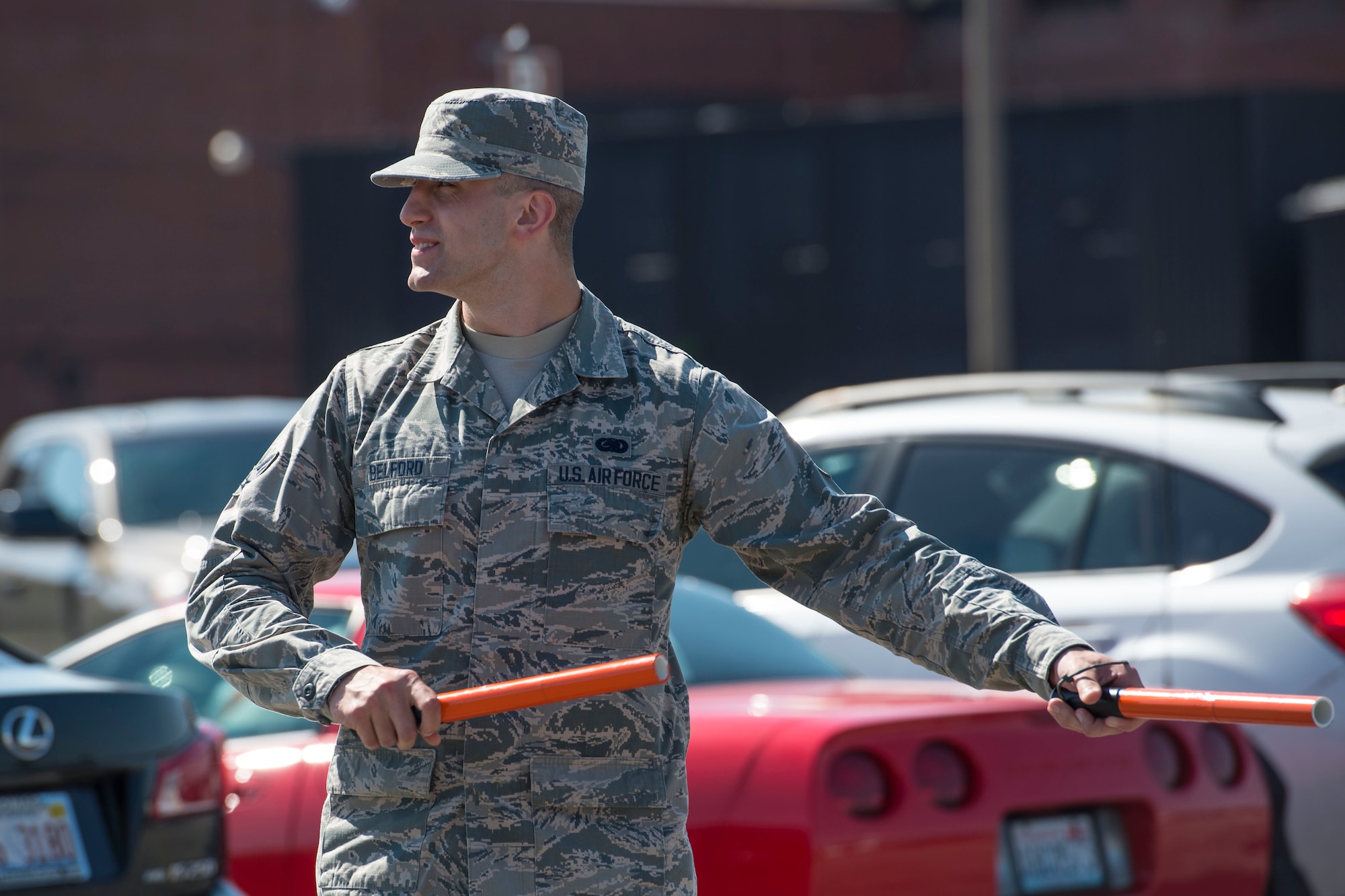 A volunteer directs traffic during the Centennial Celebration Air Show, June 11, 2017, Scott Air Force Base, Ill. Scott AFB opened in 1917, previously named Scott Field, the base has seen its mission evolve and expand to encompass a multitude of priorities, including aeromedical evacuation and communications. (U.S. Air Force photo by Senior Airman Melissa Estevez)