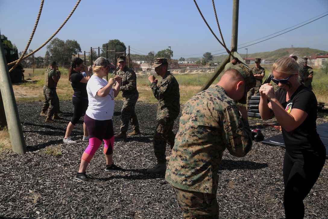 Spouses learn martial arts from Marines with 9th Communication Battalion, I Marine Expeditionary Force Headquarters Group, during the battalion’s family day, April 28, 2017, at Camp Pendleton, Calif. The event was for spouses and children to meet Marines and experience what their loved ones do on a daily basis. (U.S. Marine Corps photo by Lance Cpl. Robert Alejandre) 
