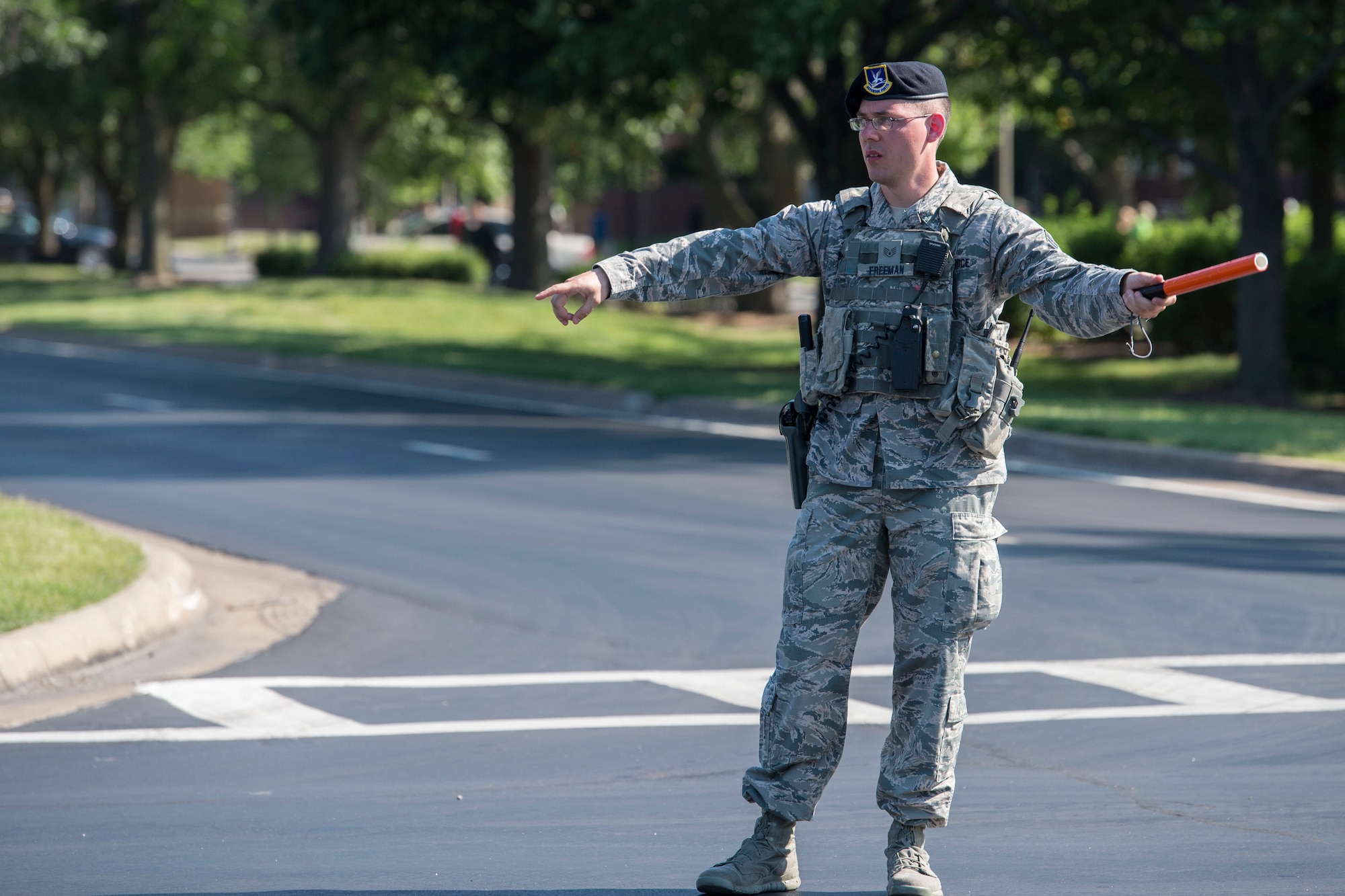 A security forces member directs traffic during the Centennial Celebration Air Show, June 11, 2017, Scott Air Force Base, Ill. Scott AFB opened in 1917, previously named Scott Field, the base has seen its mission evolve and expand to encompass a multitude of priorities, including aeromedical evacuation and communications. (U.S. Air Force photo by Senior Airman Melissa Estevez)
