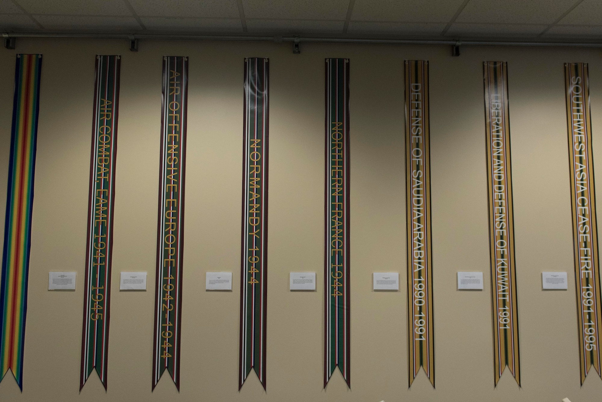 Campaign streamers line the walls on display in the auditorium room of the 33rd Special Operations Squadron during the 100-year ceremony at Cannon Air Force Base, New Mexico, June 9, 2017. The squadron has roots dating back to 1917 during World War I and since then has had a presence in nearly every major U.S. conflict. (U.S. Air Force photo by Staff Sgt. Michael Washburn/Released)