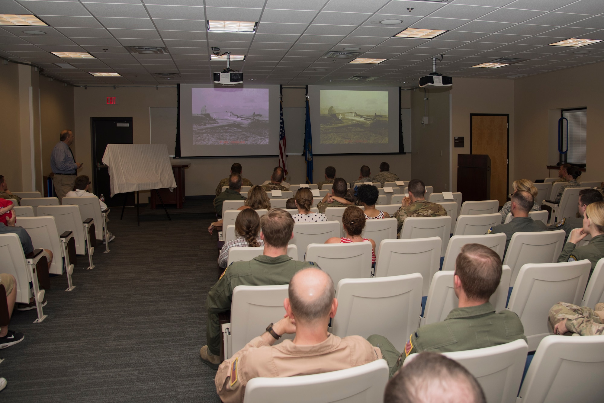 Steven Frank, 27th Special Operations Wing historian, briefs attendees during the 33rd Special Operations Squadron 100-year ceremony at Cannon Air Force Base, New Mexico, June 9, 2017. In 2009, the 33rd began operating the MQ-9 Reaper Remotely Piloted Aircraft. (U.S. Air Force photo by Staff Sgt. Michael Washburn/Released)

