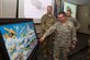 Col. Stewart Hammons, 27th Special Operations Wing commander, looks at a painting depicting the aircraft the squadron has flown during its 100-year history during the 33rd Special Operations Squadron 100-year ceremony at Cannon Air Force Base, New Mexico, June 9, 2017. The painting was done by Rodney Bohner, father of Lt. Col. Ryan Bohner, 33rd SOS commander. (U.S. Air Force photo by Staff Sgt. Michael Washburn/Released)
