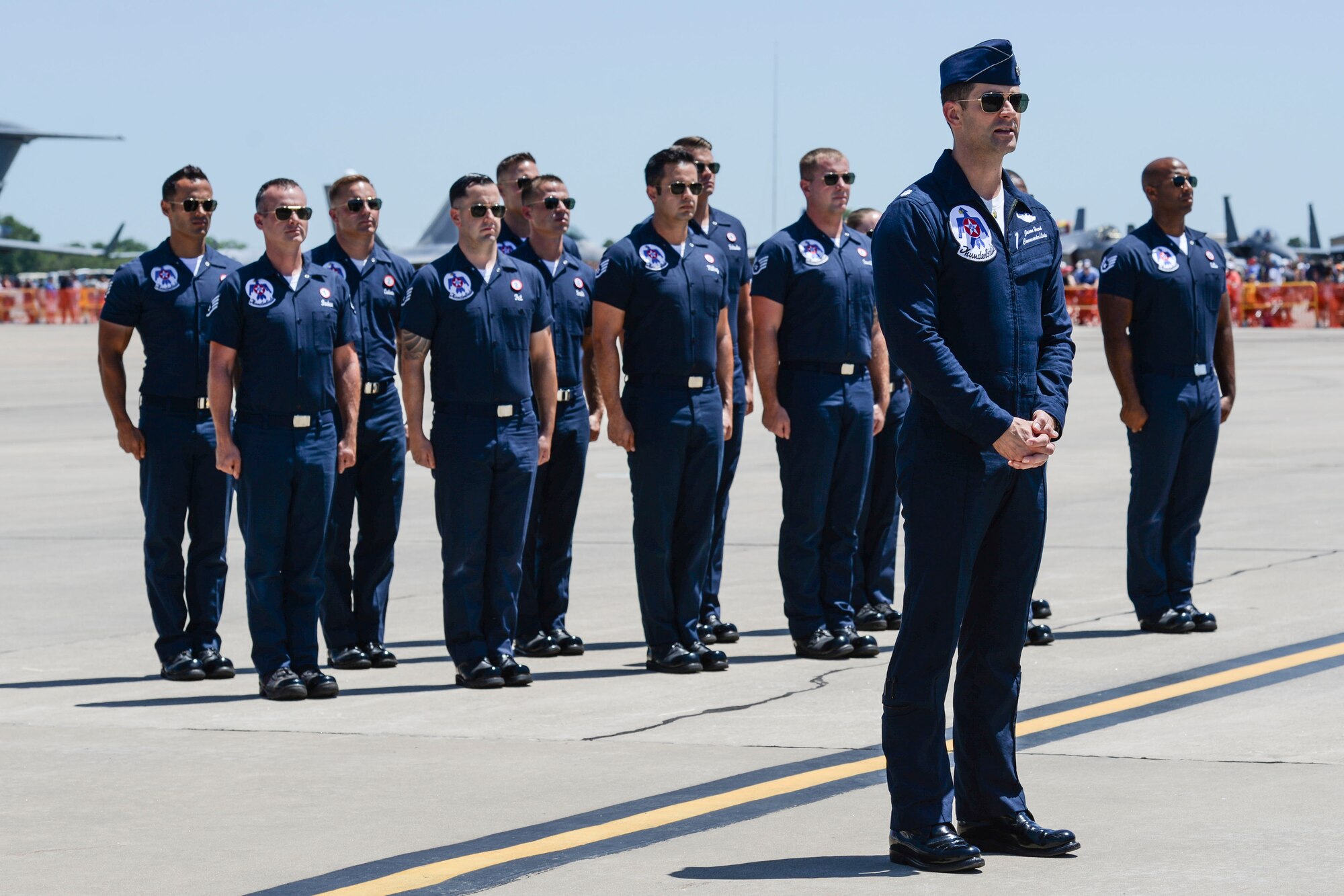 Members of the Thunderbird team prepares for a reenlistment ceremony with Scott Air Force Base personnel during the Scott Air Show, Scott Air Force Base, Ill., June 11, 2017. The base hosted the air show and open house to celebrate the 100th year of Scott AFB.  Over 50 aircraft, ranging from WWI’s Curtiss JN-4 Jenny to the currently utilized KC-135 Stratotanker, came to Scott, the fourth oldest Air Force base. Demonstrations included the Black Daggers, “Tora, Tora, Tora,” and the USAF Thunderbirds. Opened in 1917 and previously named Scott Field, the base has seen its mission evolve and expand to encompass a multitude of priorities, including aeromedical evacuation and communications.  Today, Scott is home to 31 mission partners and provides around-the-clock logistics support and rapid global mobility, carried out primarily by U.S. Transportation Command and Air Mobility Command.