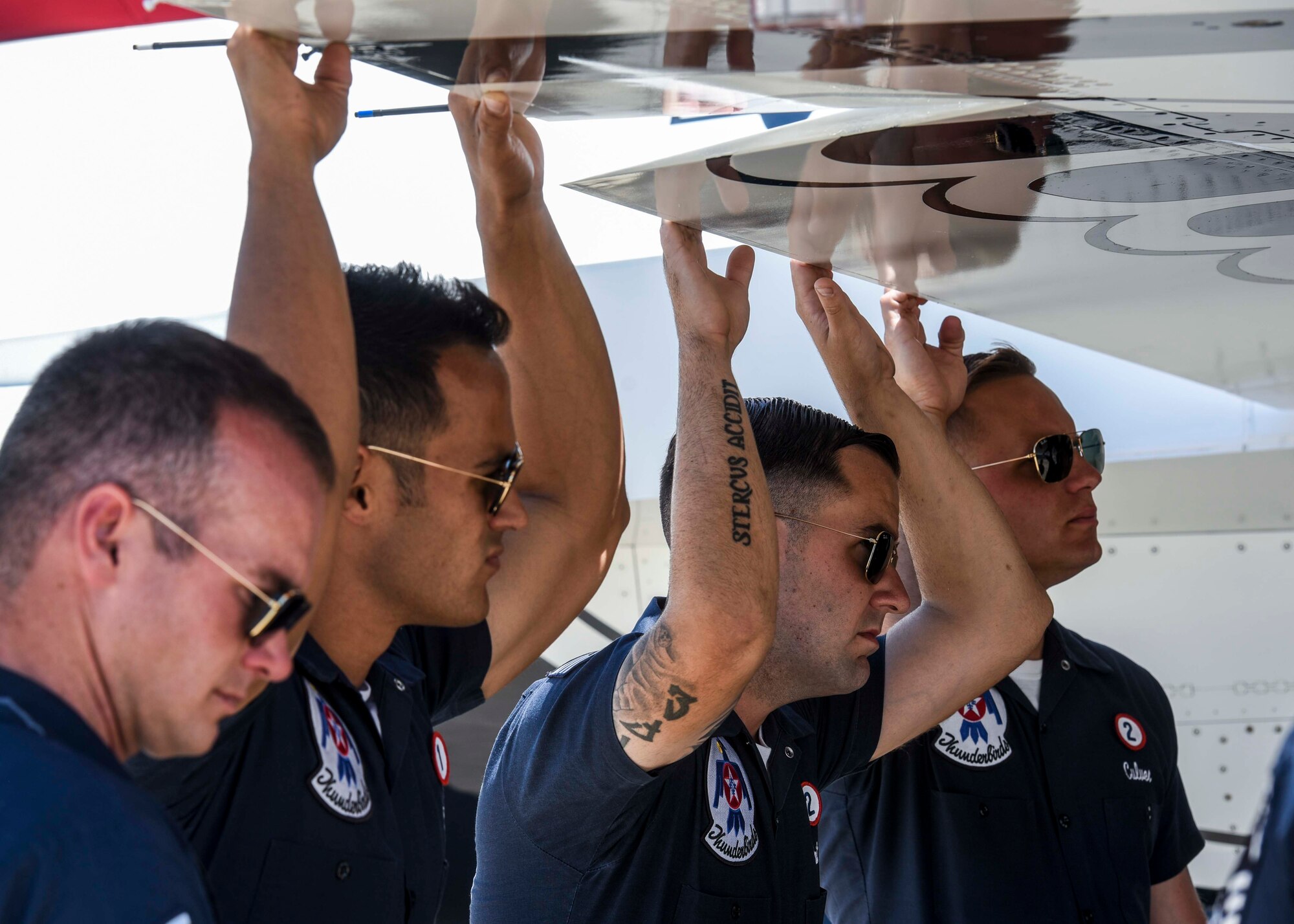 Members of the Thunderbird team prepares for a reenlistment ceremony with Scott Air Force Base personnel during the Scott Air Show, Scott Air Force Base, Ill., June 11, 2017. The base hosted the air show and open house to celebrate the 100th year of Scott AFB.  Over 50 aircraft, ranging from WWI’s Curtiss JN-4 Jenny to the currently utilized KC-135 Stratotanker, came to Scott, the fourth oldest Air Force base. Demonstrations included the Black Daggers, “Tora, Tora, Tora,” and the USAF Thunderbirds. Opened in 1917 and previously named Scott Field, the base has seen its mission evolve and expand to encompass a multitude of priorities, including aeromedical evacuation and communications.  Today, Scott is home to 31 mission partners and provides around-the-clock logistics support and rapid global mobility, carried out primarily by U.S. Transportation Command and Air Mobility Command.
