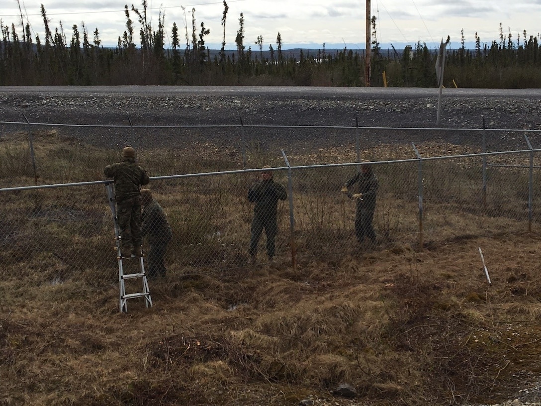 Marines with Engineer Company, Detachment Bravo, Marine Wing Support Squadron 473, 4th Marine Aircraft Wing, Marine Forces Reserve fix perimeter fencing at Canadian Armed Forces Forward Operating Location Inuvik during their annual training May 31, 2017. The Marines completed engineering projects at FOL Inuvik to increase force protection measures at FOL Inuvik during their two-week annual training period, May 26 to June 9, 2017.
