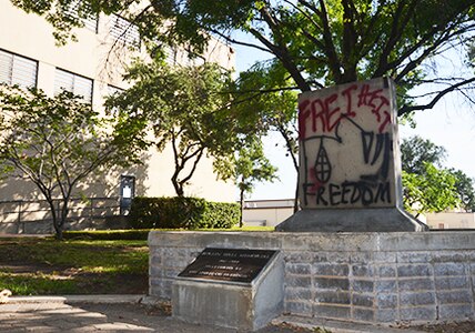 BJ Jones, 25th Air Force History office, recently spent several hours, in the dark of night, restoring a piece of history, in the form of graffiti, on the Berlin Wall exhibit in 25th Air Force’s Belvedere Park courtyard.  