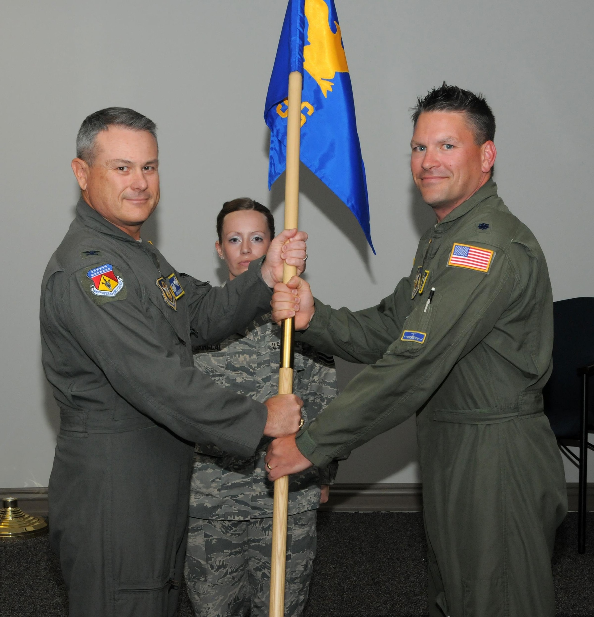 Col. Craig McPike, 445th Operations Group commander, passes the guidon to Lt. Col. David Atkinson, incoming 445th Operations Support Squadron commander, during the squadron’s change of command ceremony May 21, 2017. (U.S. Air Force photo/Tech. Sgt. Anthony Springer)