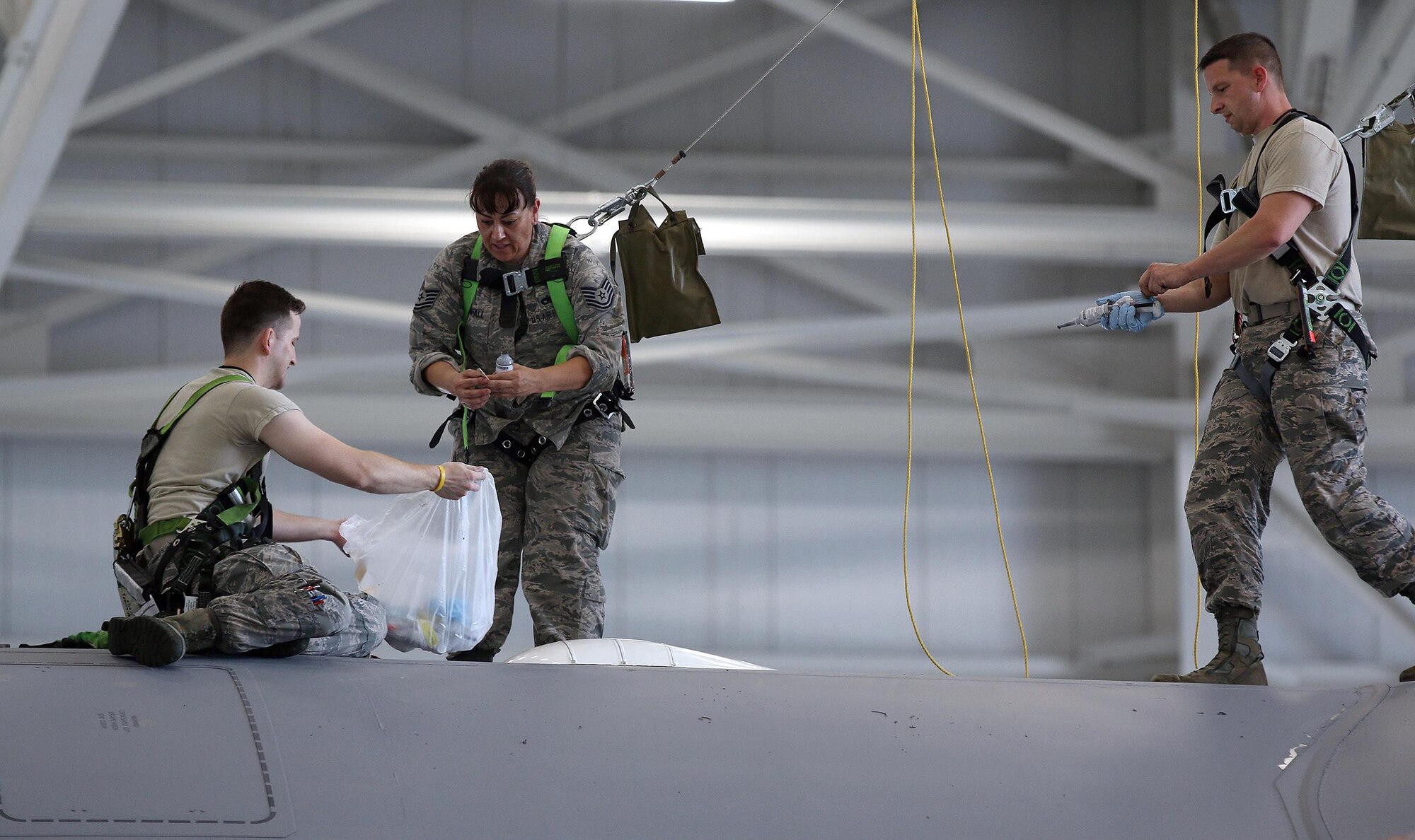445th Aircraft Maintenance Squadron electronic integrated systems mechanics Senior Airman Casey Jones, Tech. Sgt. Tame Marshall and Staff Sgt. Jeremie Jamito replace a C-17 Globemaster III satellite communications antenna during the May 21, 2017 unit training assembly. (U.S. Air Force photo/Tech. Sgt. Patrick O’Reilly)