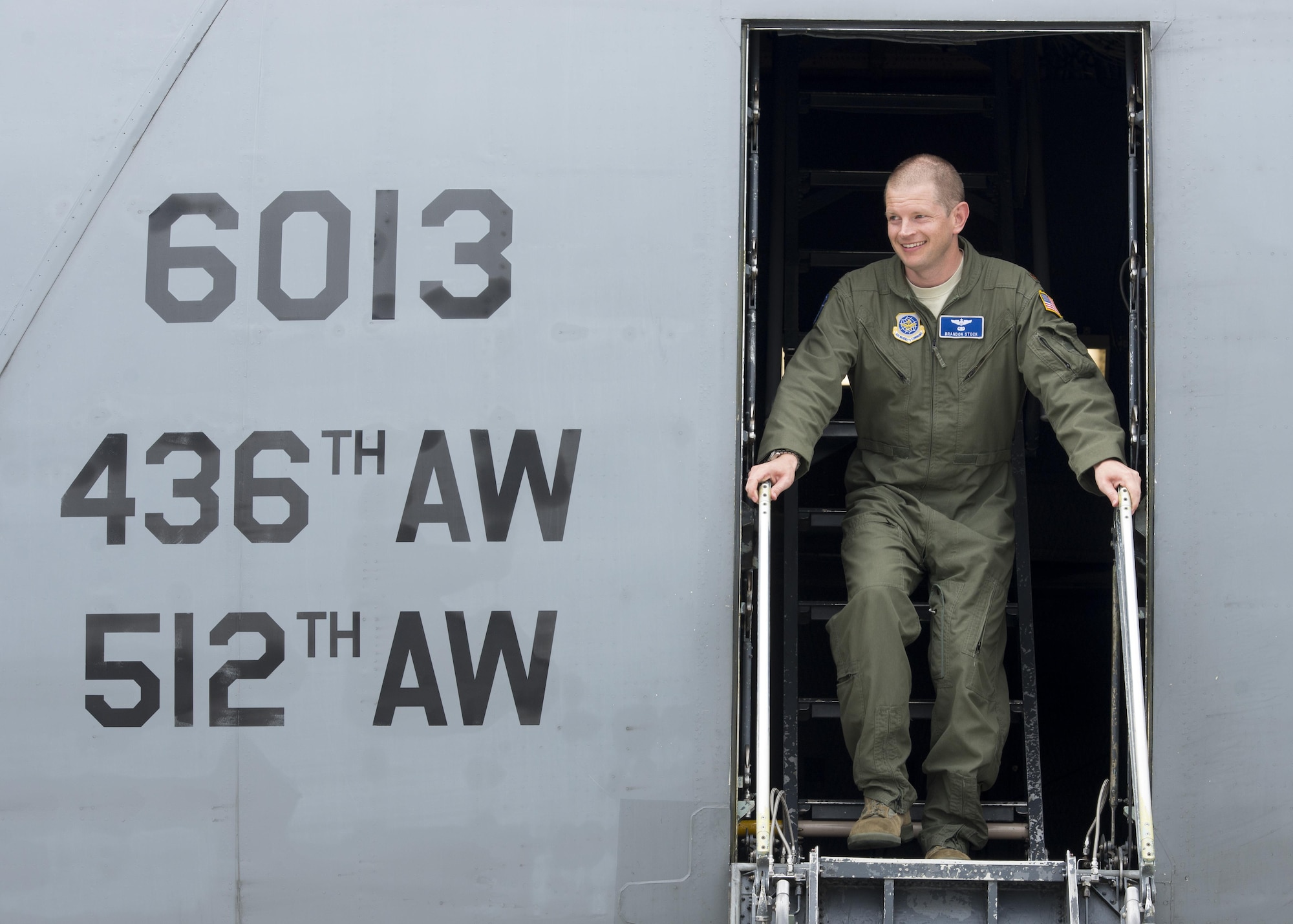 Maj. Brandon Stock, C-5M Formal Training Unit commander, steps out of a C-5M Super Galaxy after completing the FTU’s final training flight June 8, 2017, at Dover Air Force Base, Del. This flight was also Stock’s finis flight. (U.S. Air Force photo by Senior Airman Zachary Cacicia)