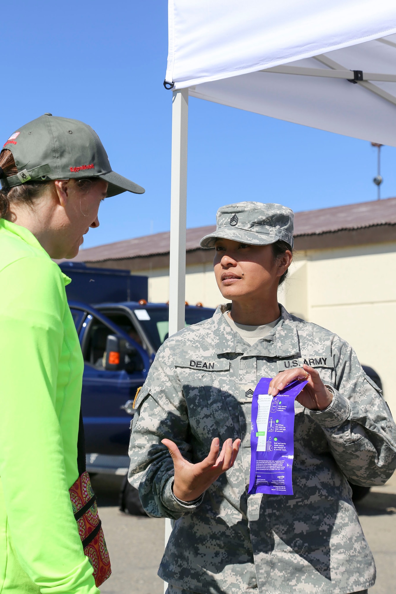Alaska National Guard Staff Sgt. Joyce Dean, the Counterdrug Support Program noncommissioned officer-in-charge, discusses how to use a drug disposal kit with a local resident at the Edward G. Pitka Sr. Airport in Galena, Alaska, May 31, 2017. The CDSP presented the goggles, a tool used to demonstrate alcohol or drug impairment, and provided drug and alcohol education and prevention materials to local residents during a recent civil operations mission in the Yukon-Koyukuk Region. (U.S. Army National Guard photo by Staff Sgt. Balinda O’Neal Dresel)