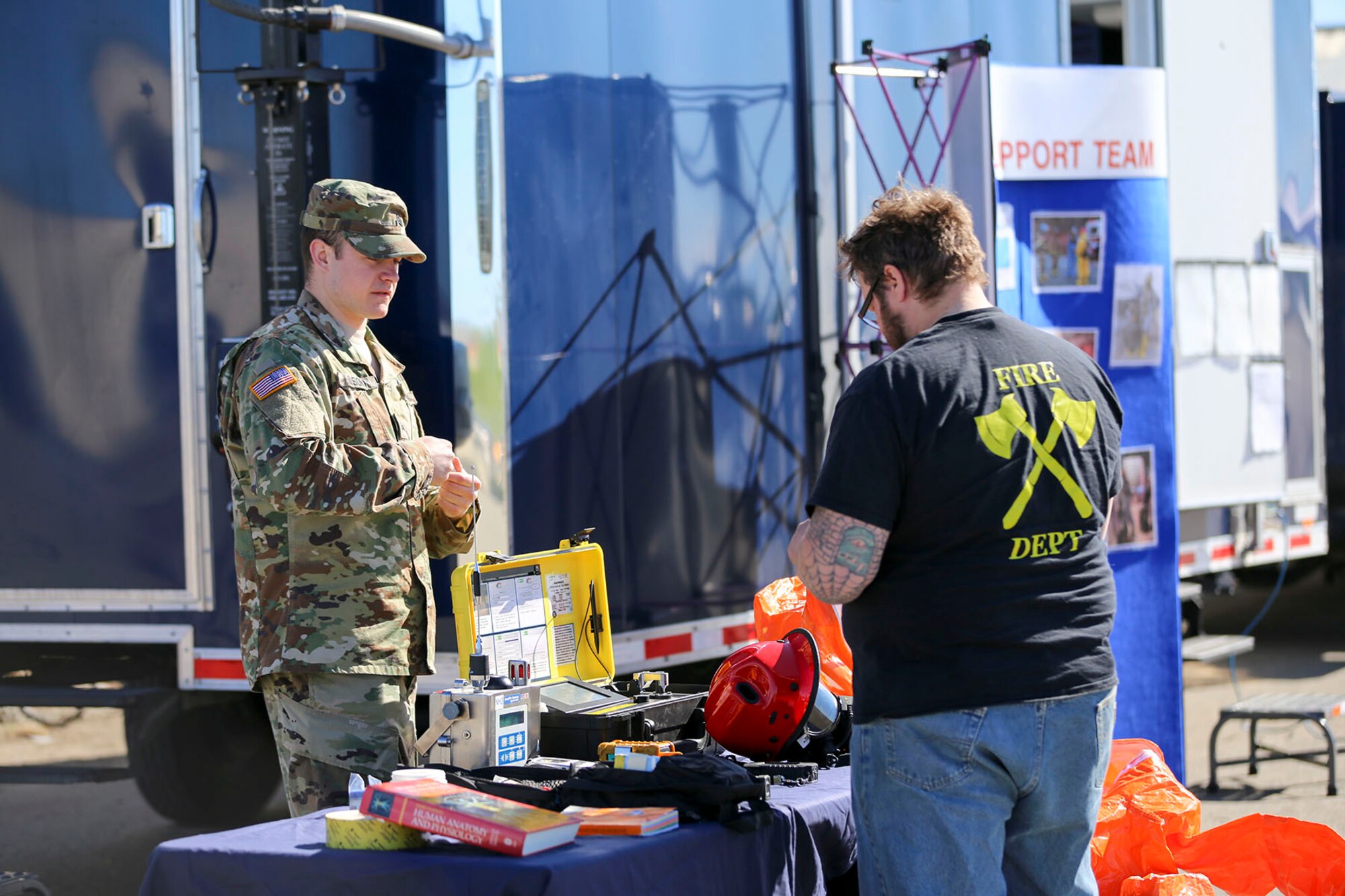 Alaska Guard Sgt. Bradly Olson, a chemical, biological, radiological and nuclear noncommissioned officer with the 103rd Civil Support Team (Weapons of Mass Destruction), briefs a local resident on CST capabilities at the Edward G. Pitka Sr. Airport in Galena, Alaska, May 31, 2017. More than 30 service members from the Alaska National Guard and United States Military Entrance Processing Command teamed up to provide community outreach efforts with residents of the Yukon River village. (U.S. Army National Guard photo by Staff Sgt. Balinda O’Neal Dresel)