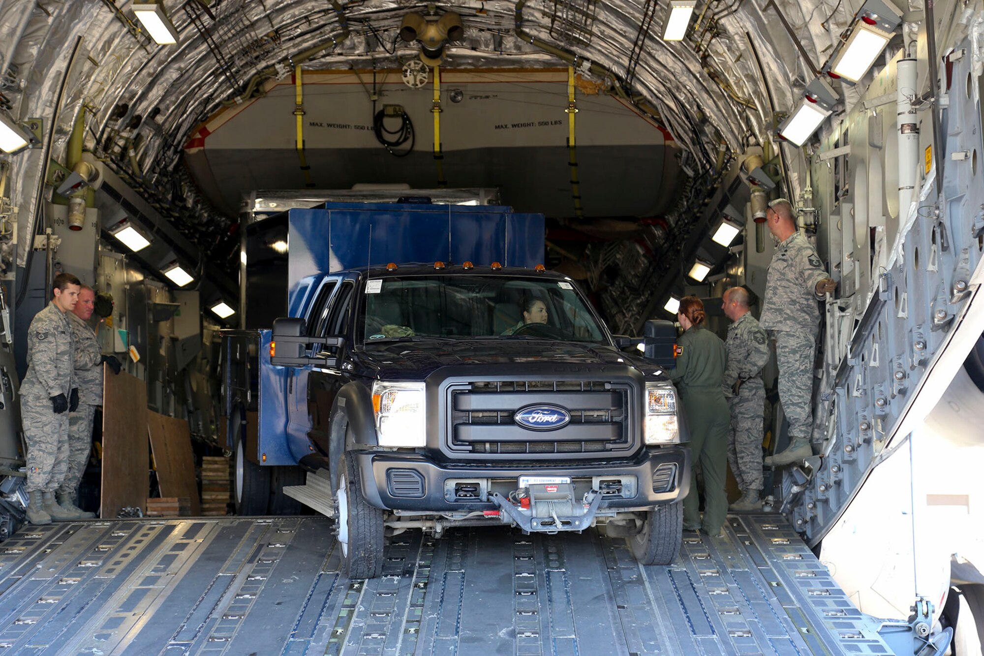 Alaska Guard Master Sgt. Nina Kolyvanova, 103rd Civil Support Team (Weapons of Mass Destruction) training noncommissioned officer, backs the operations truck and trailer onto a C-17 Globemaster III aircraft crewed by the 176th Wing’s 249th Airlift Squadron after interacting and providing outreach to local residents at the Edward G. Pitka Sr. Airport in Galena, Alaska, May 31, 2017. (U.S. Army National Guard photo by Staff Sgt. Balinda O’Neal Dresel)