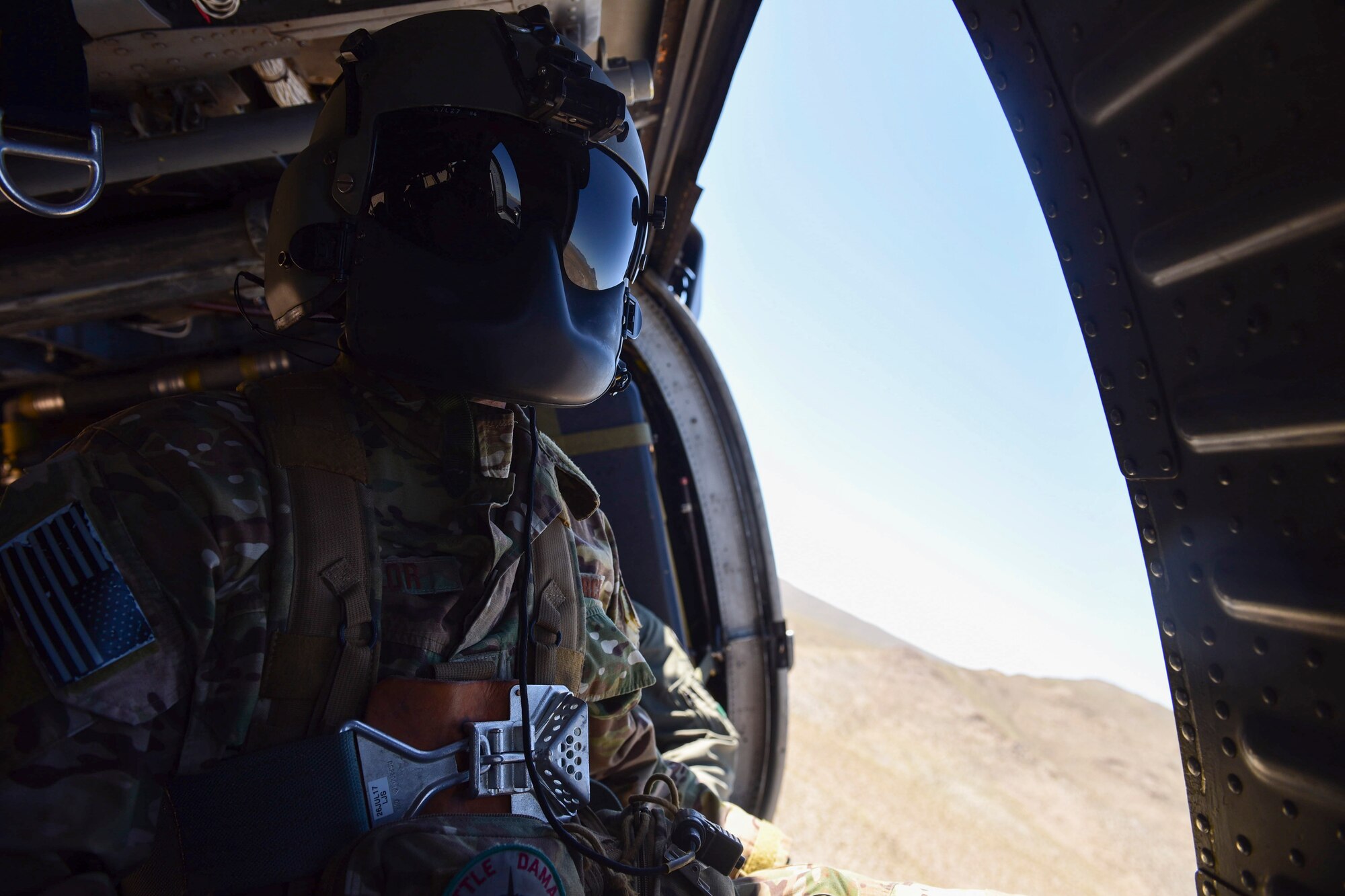 Tech. Sgt. Brandon Taylor, 34th Weapons Squadron special mission aviator, rides an HH-60G Pave Hawk helicopter during a Weapons School Integration mission at the Nevada Test and Training Range June 1, 2017. The HH-60 is the Air Force’s premier search and rescue helicopter and is also capable of providing humanitarian relief during natural disasters. (U.S. Air Force photo by Airman 1st Class Andrew D. Sarver/Released)