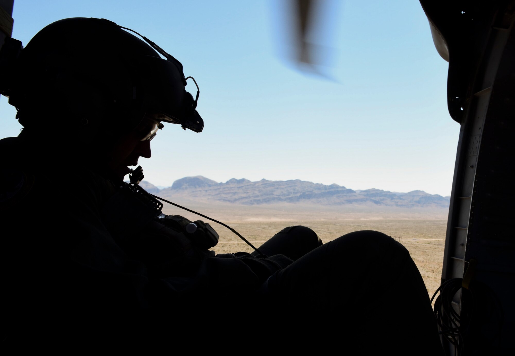 A 34th Weapons Squadron instructor pilot talks to the crew during a Weapons School Integration mission at the Nevada Test and Training Range June 1, 2017. The instructor pilot evaluated the crew on their ability to safely and effectively complete their simulated combat search and rescue mission. (U.S. Air Force photo by Airman 1st Class Andrew D. Sarver/Released)