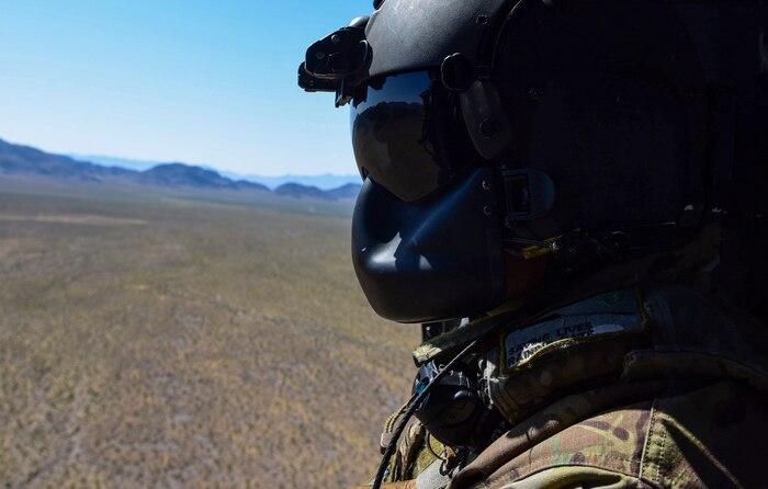 Staff Sgt. Christian Nault, 34th Weapons Squadron special mission aviator, rides an HH-60G Pave Hawk helicopter during a Weapons School Integration mission at the Nevada Test and Training Range June 1, 2017. The Pave Hawk crews were evaluated on their ability to successfully complete a combat search and rescue mission. (U.S. Air Force photo by Airman 1st Class Andrew D. Sarver/Released)