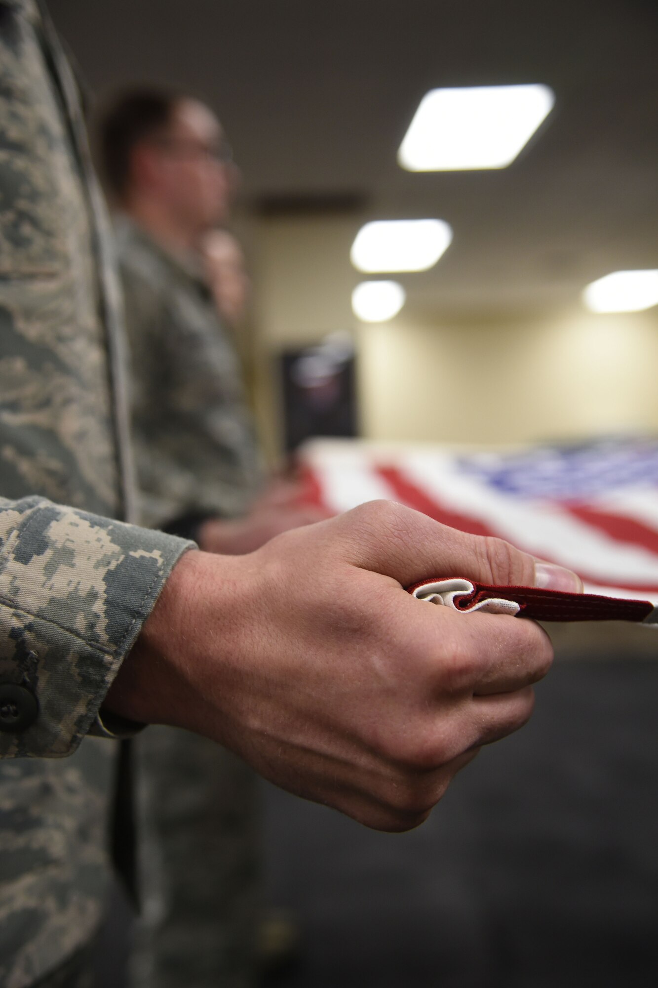 Staff Sgt. Marcus Hasse, Fairchild Air Force Base honor guardsmen, grips the American Flag during a six-man flag fold June 12, 2017, at Fairchild AFB, Washington. Fairchild’s honor guardsmen perform numerous types of ceremonies, to include; two-man and six-man flag folding sequences, colors presentation, colors posting and marching in parades. (U.S. Air Force photo/SrA Sean Campbell)