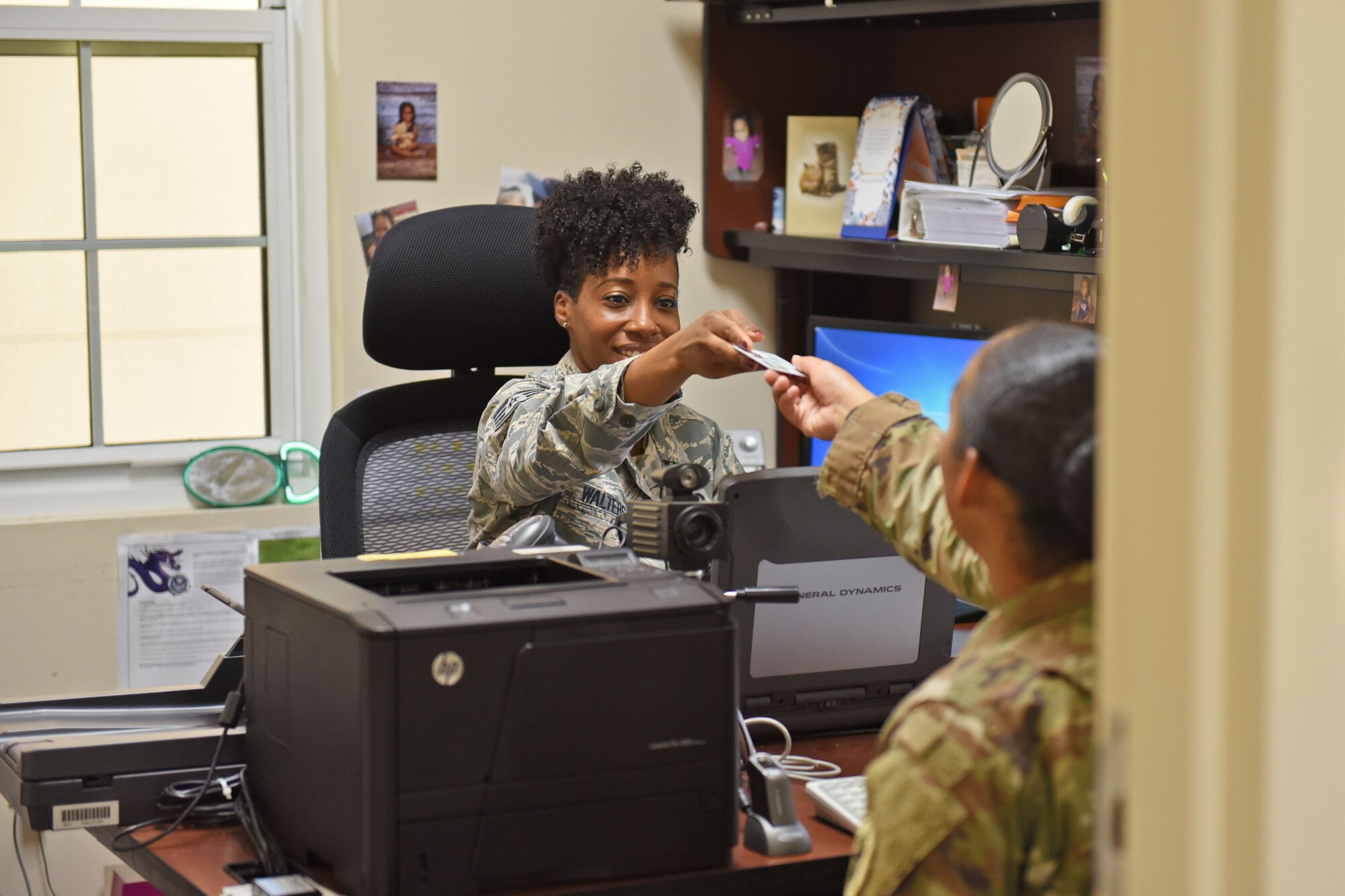 Staff Sgt. Jenerian Walters, Joint Task Force-Bravo personnel office, provides a Common Access Card to one of her customers at Soto Cano Air Base, Honduras, June 5th, 2017. Staff Sgt. Walters works as the Admin non-commissioned officer at JTF-Bravo’s personnel office and her Call to Duty includes making sure everyone has the proper credentials and working Common Access Cards for their computers. Without a CAC service members cannot access the computer system and cannot perform a great part of their duties. 