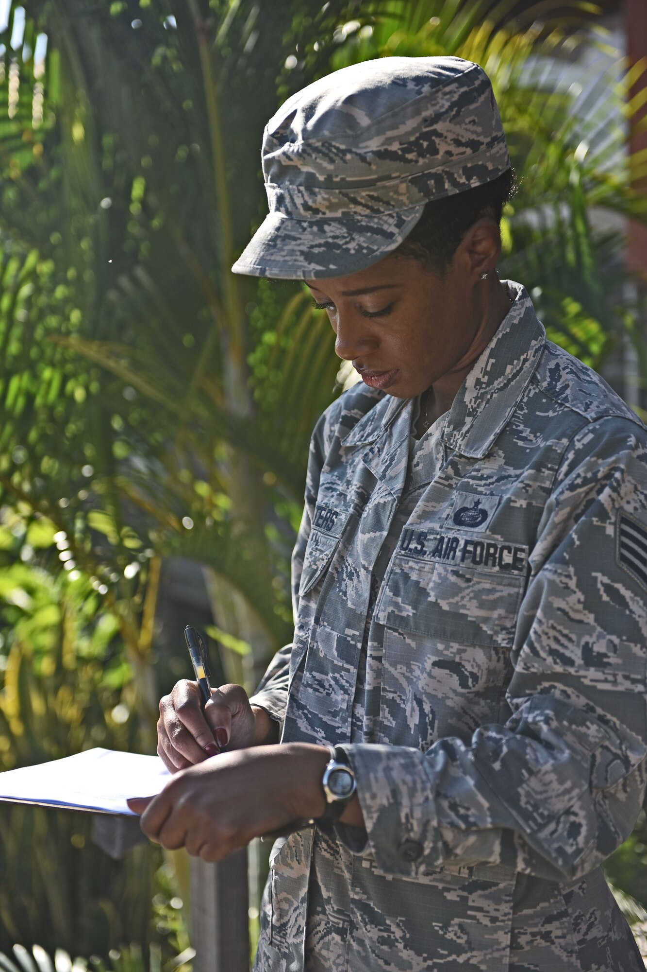 Staff Sgt. Jenerian Walters, Joint Task Force-Bravo personnel office, checks the passenger list for the Soto Cano shuttle bus that will transport deployed personnel to the airport for their return home after completing an assignment at JTF-Bravo. Staff Sgt. Walters Call to Duty as the Admin non-commissioned officer at JTF-Bravo begins at 7:45 am as she waits for shuttle bus passengers at the bus stop. 