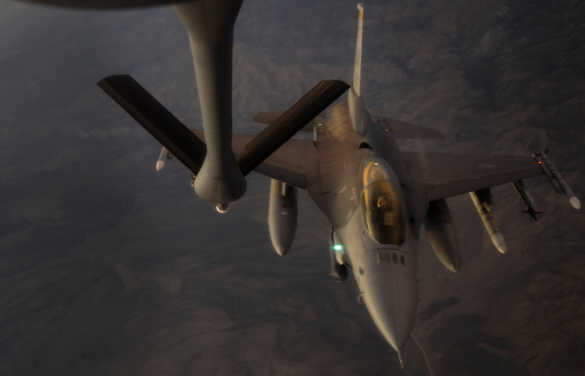 A KC-135 Stratotanker refueling aircraft, assigned to the 509th Weapons Squadron at Fairchild Air Force Base, Wash., prepares to refuel an F-16 Fighting Falcon fighter jet during a Weapons School integration mission over the Nevada Test and Training Range, June 8, 2017. At the conclusion of nearly 400 hours of graduate-level academics and combat training missions, the Weapons School course climaxes with a week-long exercise, known as Weapons School Integration. (U.S. Air Force photo by Senior Airman Kevin Tanenbaum/Released)


