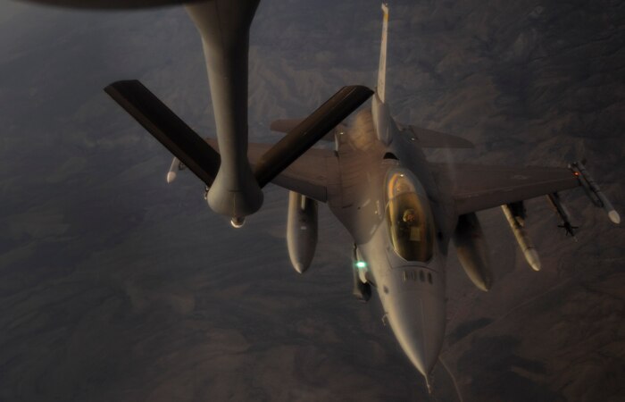 A KC-135 Stratotanker refueling aircraft, assigned to the 509th Weapons Squadron at Fairchild Air Force Base, Wash., prepares to refuel an F-16 Fighting Falcon fighter jet during a Weapons School integration mission over the Nevada Test and Training Range, June 8, 2017. At the conclusion of nearly 400 hours of graduate-level academics and combat training missions, the Weapons School course climaxes with a week-long exercise, known as Weapons School Integration. (U.S. Air Force photo by Senior Airman Kevin Tanenbaum/Released)

