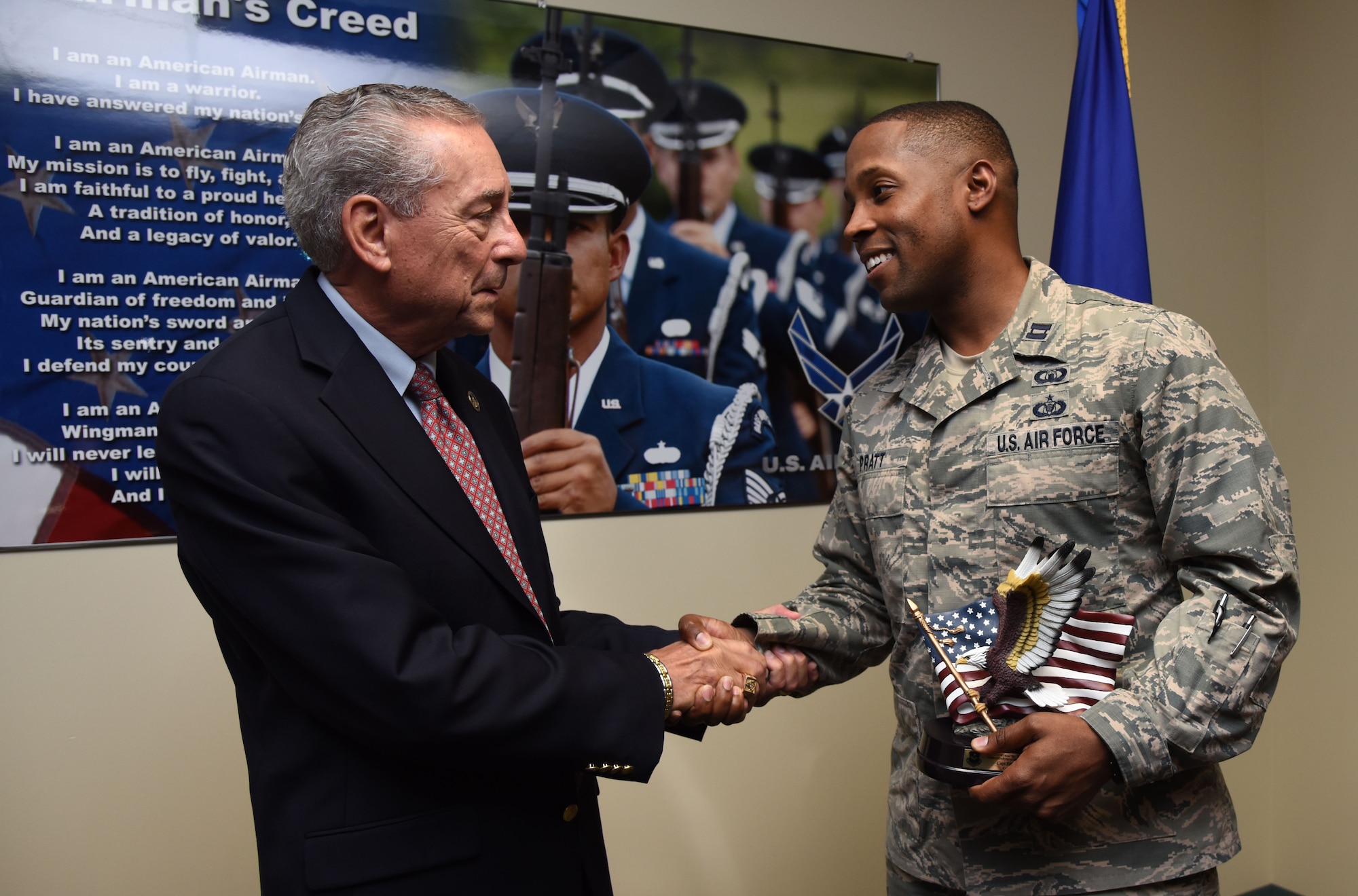 Retired Chief Master Sgt. Byron “BT” Parcenue presents Capt. Edwin Pratt, 81st Training Wing executive officer, the Byron“BT” Parcenue Airfield Operations Professional of the Year, during an awards presentation at Cody Hall June 8, 2017, on Keesler Air Force Base, Miss. This was a 2016 Air Education and Training Command Airfield Operations Annual Award. (U.S. Air Force photo by Kemberly Groue)