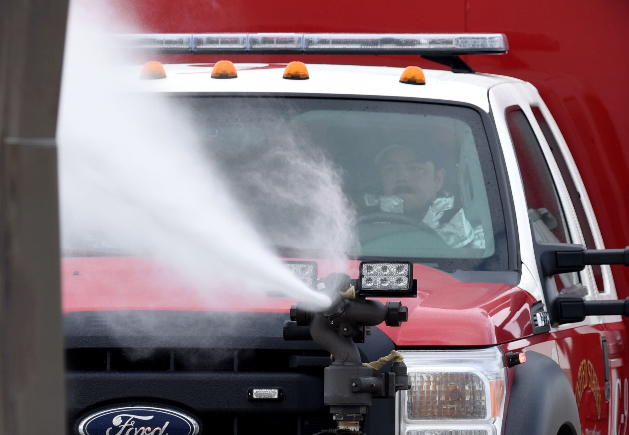 Staff Sgt. Logan Knutson, 81st Infrastructure Division firefighter, attempts to extinguish a firefighter training aid during live fire exercise on the flightline June 7, 2017, on Keesler Air Force Base, Miss. The Keesler Fire Department, the Gulfport CRTC Fire Department and the Stennis Space Center Fire Department are all required to practice Aircraft Rescue and Fire Fighting procedures to meet a semi-annual training requirement. (U.S. Air Force photo by Kemberly Groue)