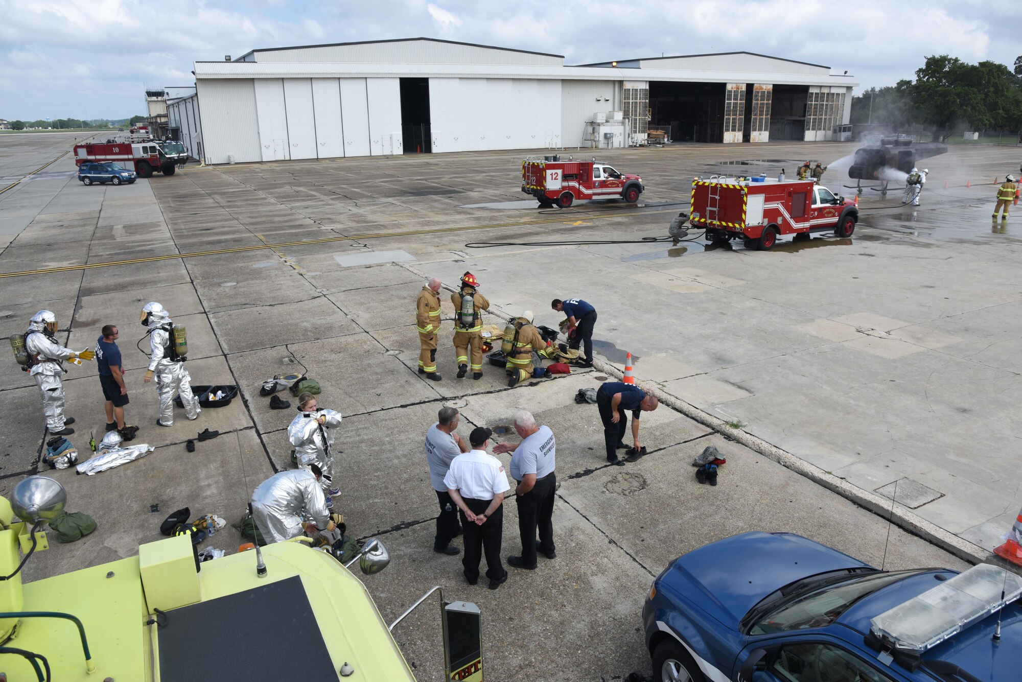 Firefighters from the Keesler Fire Department, the Gulfport Combat Readiness Training Center Fire Department and the Stennis Space Center Fire Department participate in live firefighting training June 7, 2017, on Keesler Air Force Base, Miss. The fire departments practiced Aircraft Rescue and Fire Fighting procedures to meet a semi-annual training requirement. (U.S. Air Force photo by Kemberly Groue)