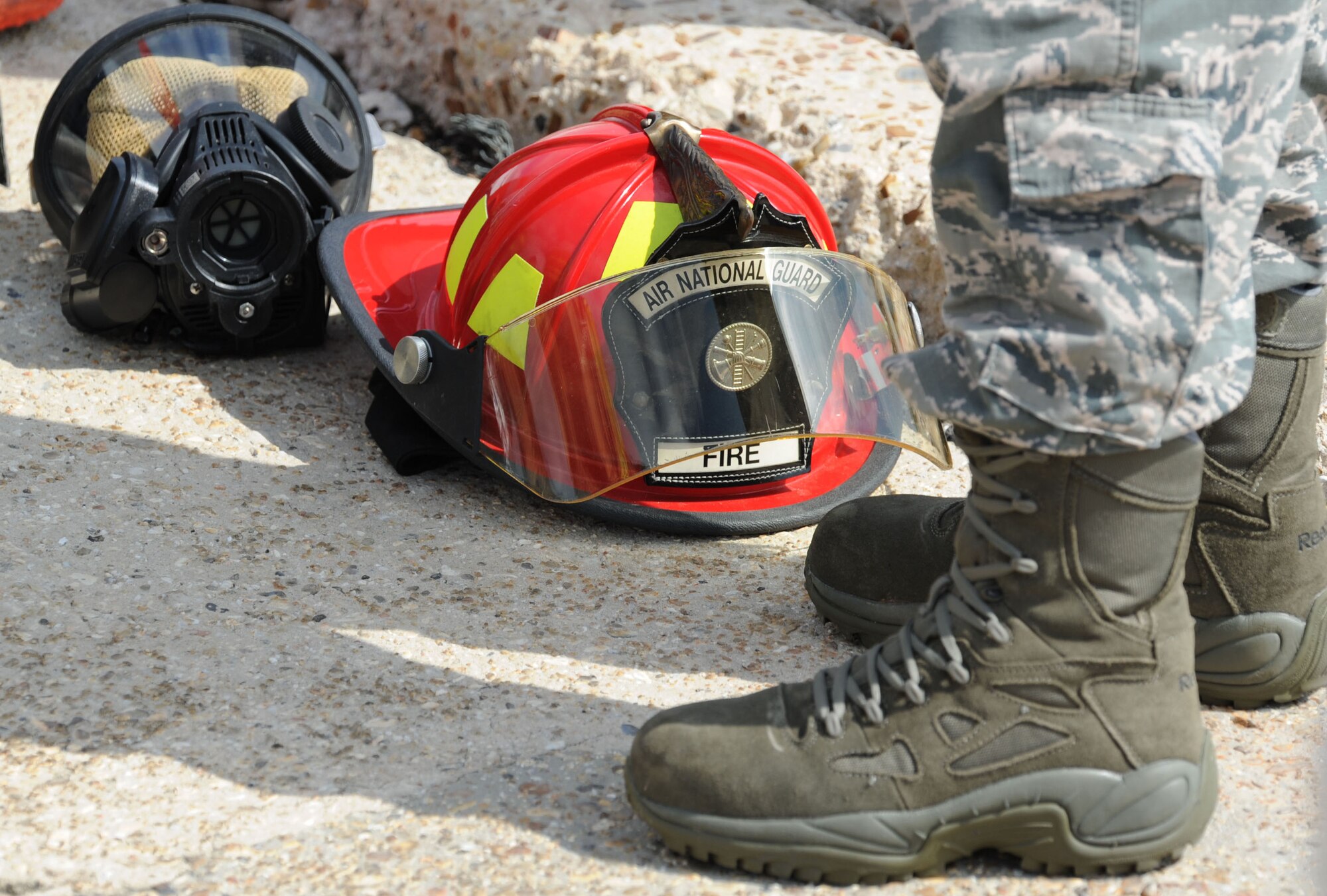 A Gulfport Combat Readiness Training Center firefighter helmet sits on the ground during a live fire exercise on the flightline June 7, 2017, on Keesler Air Force Base, Miss. The Keesler Fire Department, the Gulfport CRTC Fire Department and the Stennis Space Center Fire Department are all required to practice Aircraft Rescue and Fire Fighting procedures to meet a semi-annual training requirement. (U.S. Air Force photo by Kemberly Groue)