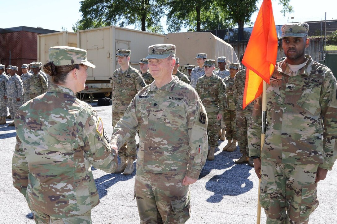 Army Reserve Lt. Col. James A. Freitag, staff chaplain, 335th Signal Command (Theater) shakes hands with Brig. Gen. Nikki Griffin-Olive, deputy commanding general of sustainment, 335th SC (T) during an awards ceremony at the unit headquarters in East Point, Georgia in May.  Freitag, who is nearing retirement, is one of only two Soldiers in the history of the Army who has served as a command sergeant major and as a chaplain. (Official U.S. Army Reserve photo by Sgt. 1st Class Brent C. Powell)