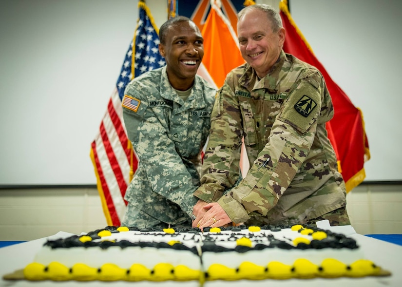 U.S. Army Reserve Lt. Col. James Freitag, command support chaplain for the 335th Signal Command (Theater), and Private 1st Class Maurice Montgomery, a medic, cut a cake to celebrate the Army's 242nd birthday, which will take place on June 14. It is tradition for the Soldiers with the most and least amount of time in service to cut the cake together. Freitag is 59 and has been serving our country for 36 years, Montgomery is 22 and has been in for two months. (Official U.S. Army Reserve photo by Staff Sgt. Ken Scar)