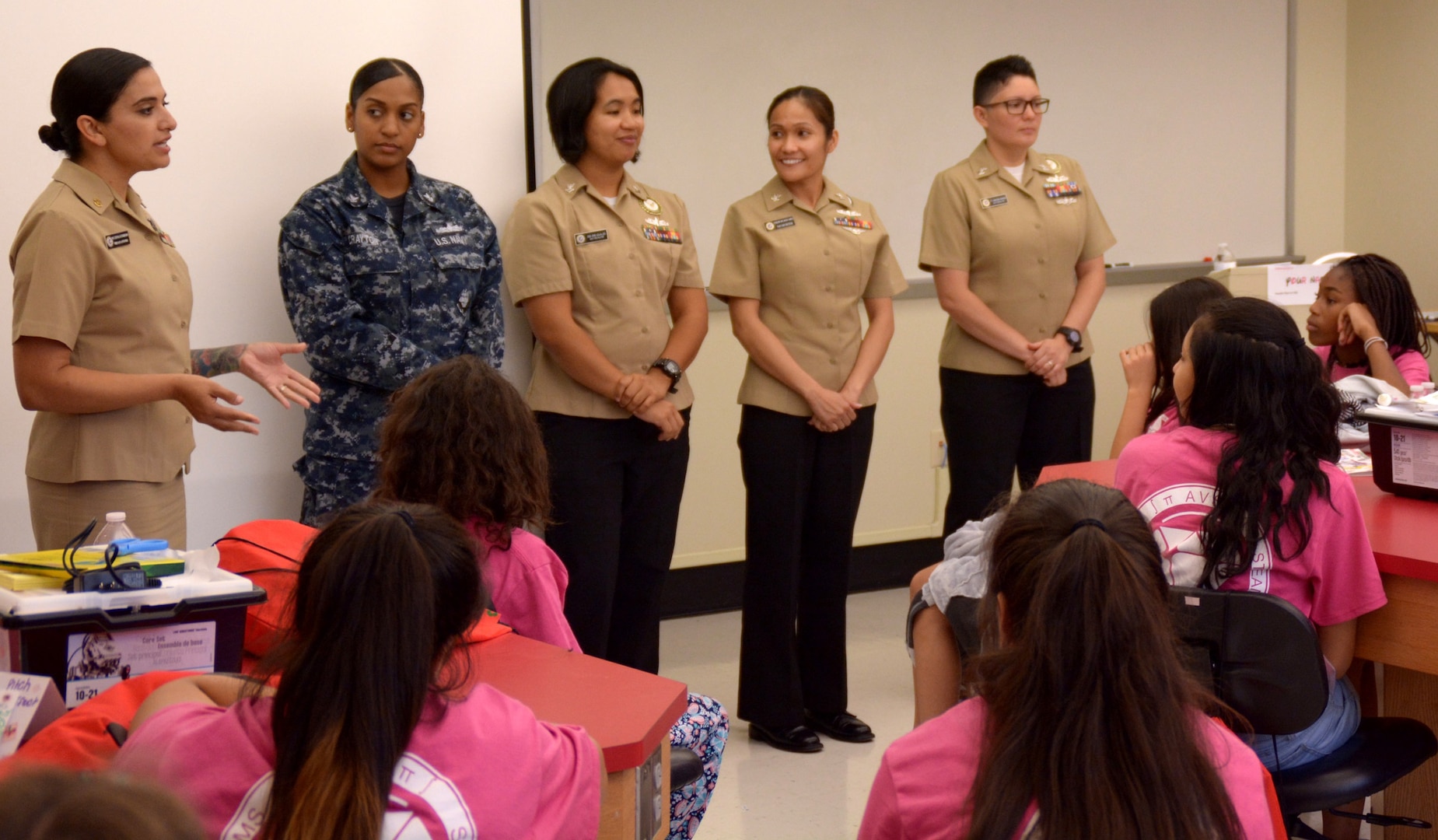 Chief Petty Officer Isabel Guerrero, Navy Reserve Officers Training Corps coordinator for Navy Recruiting District (NRD) San Antonio, joined by fellow recruiters, speaks with middle school girls during SeaPerch Day held at the Ann Barshop Natatorium on the campus of the University of the Incarnate Word as a part of the miniGEMS (Girls in Engineering, Math and Sciences) Science, Technology, Engineering, and Mathematics (STEM) Camp.  SeaPerch is an innovative underwater robotics program that equips teachers and students with the resources they need to build an underwater ROV in an in-school or out-of-school setting.