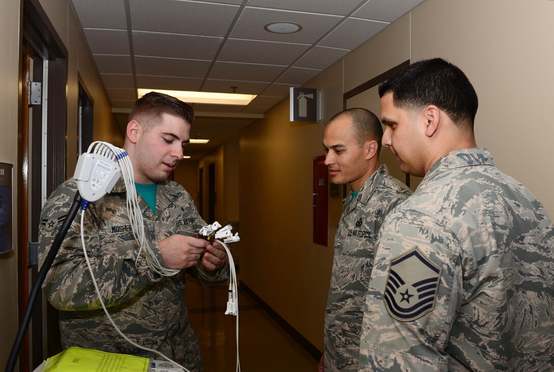 Airman 1st Class Dylan Mosher, an aerospace medical technician assigned to the 28th Medical Group, shows Master Sgt. Nathan Landry, the first sergeant assigned to the 28th MDG, and Master Sgt. Luis Guillen-Diaz, the mental health flight chief and additional-duty first sergeant assigned to the 28th MDG, an electric cardiogram machine at Ellsworth Air Force Base, S.D., June 9, 2017. Guillen-Diaz shadowed Landry as he checked on various Airmen throughout the group. (U.S. Air Force photo by Airman 1st Class Donald C. Knechtel)