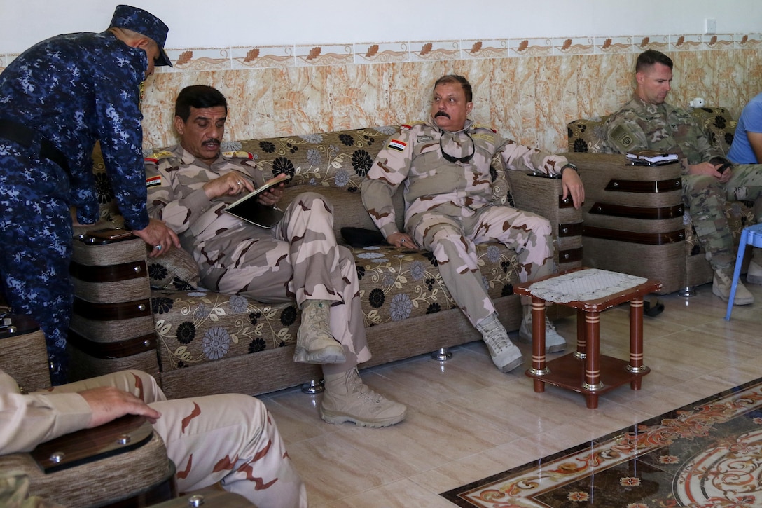 U.S. Army and Iraqi security force leaders discuss plans for a new tactical assembly area, near Mosul, Iraq, June 7, 2017. The Iraqi commanders met with U.S. Army Soldiers, deployed in support of Combined Joint Task Force - Operation Inherent Resolve and assigned to 2nd Brigade Combat Team, 82nd Airborne Division, whose mission is to enable their partners through the advise and assist mission, contributing planning, intelligence collection and analysis, force protection, and precision fires to achieve the military defeat of ISIS. CJTF-OIR is the global Coalition to defeat ISIS in Iraq and Syria. (U.S. Army photo by Staff Sgt. Jason Hull)
