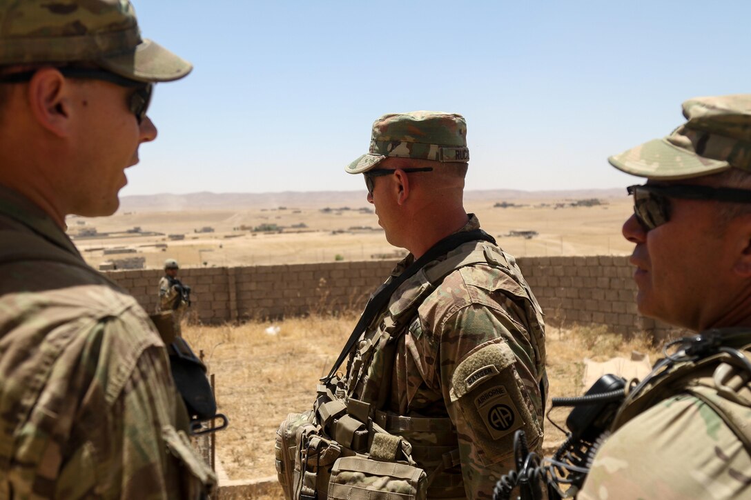 U.S. Army Soldiers deployed in support of Combined Joint Task Force - Operation Inherent Resolve and assigned to 2nd Brigade Combat Team, 82nd Airborne Division, discuss where to emplace indirect fires assets during a reconnaissance for a new tactical assembly area from which to advise and assist Iraqi security force partners, near Mosul, Iraq, June 7, 2017. The 2nd BCT, 82nd Abn. Div. enables their ISF partners through the advise and assist mission, contributing planning, intelligence collection and analysis, force protection, and precision fires to achieve the military defeat of ISIS. CJTF-OIR is the global Coalition to defeat ISIS in Iraq and Syria. (U.S. Army photo by Staff Sgt. Jason Hull)