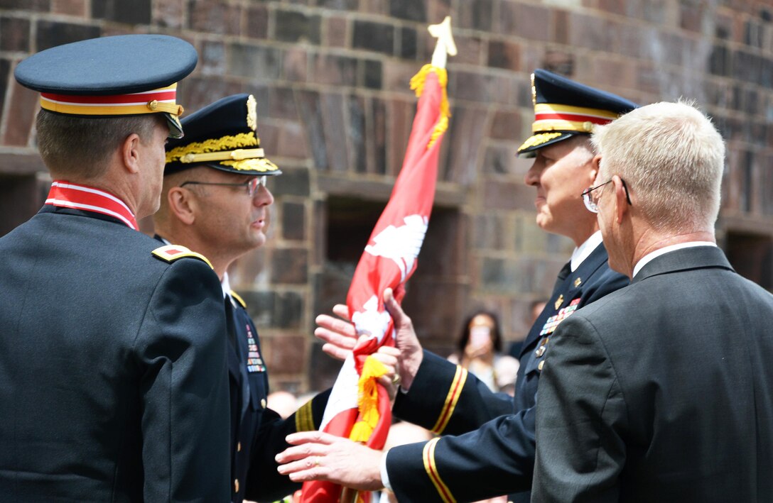 Brig. Gen. William H. Graham, Commanding General, Army Corps' North Atlantic Division, (left) passes the Army Corps flag to Col. Thomas Asbery, New York District's 53rd Commander, as the outgoing Commander, Col. David Caldwell and Joseph J. Seebode, New York District's DPM look on. The event was held June 8, 2017 on Governors Island, New York City.