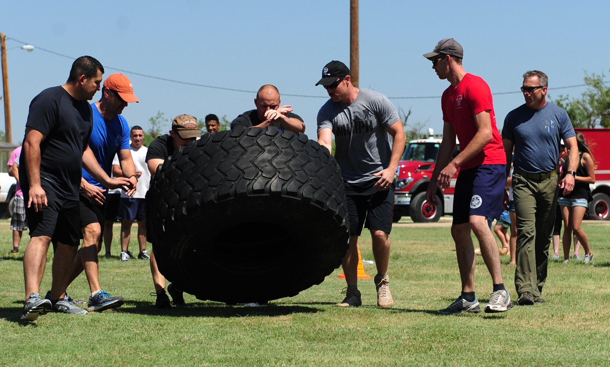 The Abilene Fire Department team flips a tire during Battle of the Badges at Dyess Air Force Base, Texas, June 10, 2017. Battle of the Badges is an event which brings together emergency response forces from Abilene and Dyess AFB to build comradery and partnership. (U.S. Air Force photo by Airman 1st Class April Lancto)