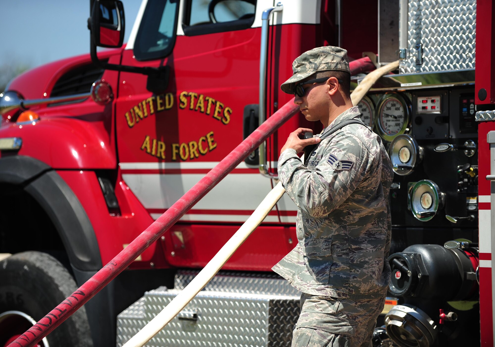 U.S. Air Force Senior Airman Aaron Cooper, 7th Civil Engineer Squadron Fire Prevention journeyman, prepares to turn on a water hose during Battle of the Badges at Dyess Air Force Base, Texas, June 10, 2017. The purpose of Battle of the Badges is to bring together emergency response forces from Dyess AFB and the local community by competing against one another in timed events. (U.S. Air Force photo by Airman 1st Class April Lancto)