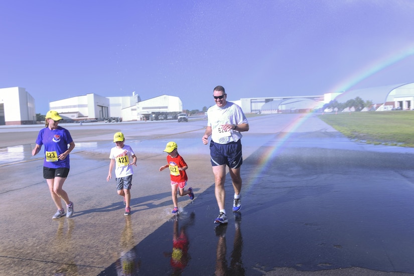 Col. Robert Lyman, Joint Base Charleston commander, right, runs with his wife, Nancy, left, and his two daughters, Ava, age 9, center left, and Brooke, age 6, center right in Joint Base Charleston’s 9th annual Run the Runway here, June 10. Two hundred and seventy nine runners consisting of military members, their families and civilians participated in the run alongside 100 volunteers.