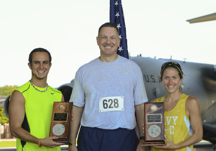Col. Robert Lyman, Joint Base Charleston commander, center, congratulates Clay Askew, Space and Naval Warfare Systems Command civilian contractor, left, and U.S. Navy Lt. Katherine Wirtz, Naval Nuclear Power Training Command instructor, right, for being the first male and female to cross the finish line at Joint Base Charleston’s 9th annual Run the Runway here, June 10. Two hundred and seventy nine runners consisting of military members, their families and civilians participated in the run alongside 100 volunteers. (U.S. Air Force photo/Senior Airman Thomas T. Charlton)