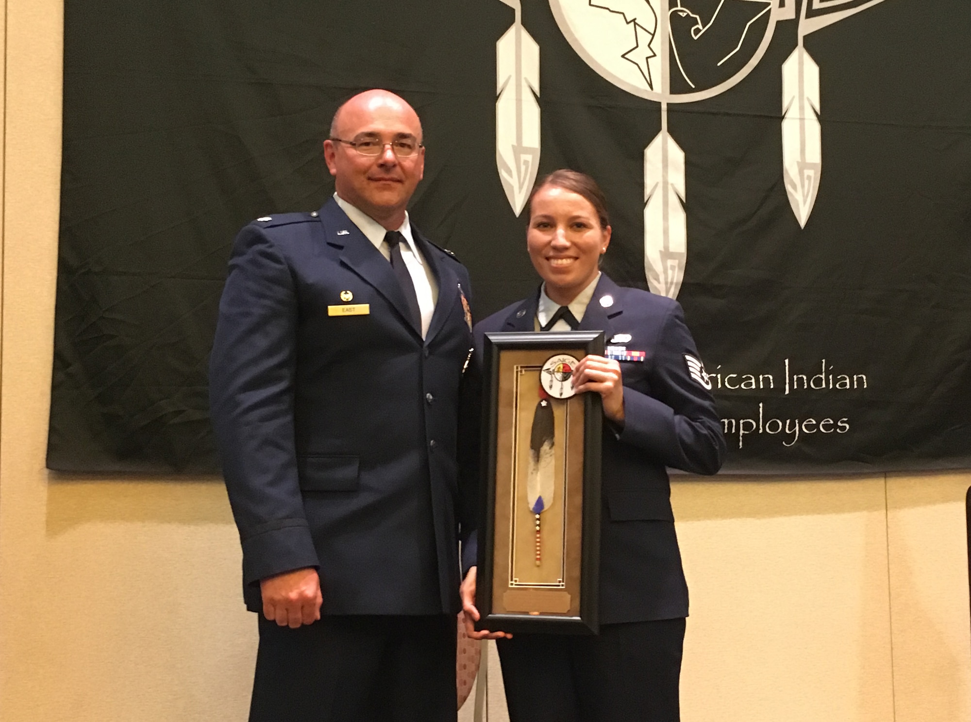 U.S. Air National Guard Staff Sgt. Trisha Ross and Lt. Col. Brandon East display the award Ross received from SAIGE for Meritorious Military Service during a ceremony held on June 8, 2017 in Scottsdale, Ariz. Ross is assigned to the Security Forces Squadron with the Iowa Air National Guard's 185th Air Refueling Wing in Sioux City, Iowa. (Courtesy Photo from Staff Sgt. Ross)