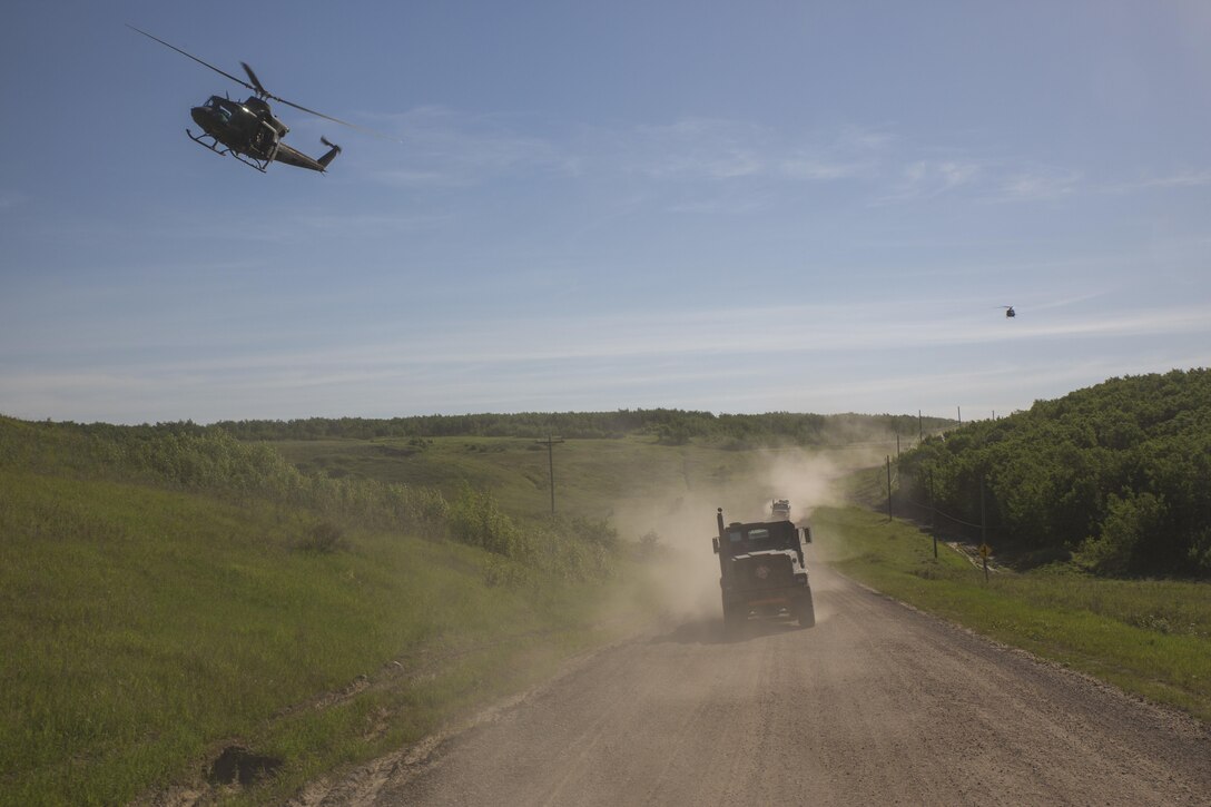 COLD LAKE, AB, CANADA -- Marines assigned to Marine Wing Support Squadron 473, 4th Marine Aircraft Wing, Marine Forces Reserve, convoy to the Canadian Manoeuvre Training Centre, Camp Wainwright accompanied by two Royal Canadian Air Force Bell CH-146 Griffons in Alberta, Canada, May 30, 2017, during exercise Maple Flag 50. MWSS-473 convoyed to the training center to provide real world refueling support to Royal Canadian Air Force CH-147 Chinook and CH-146 Griffon type model series during exercise Maple Flag 50. (U.S. Marine Corps Photo by Lance Cpl. Niles Lee)
