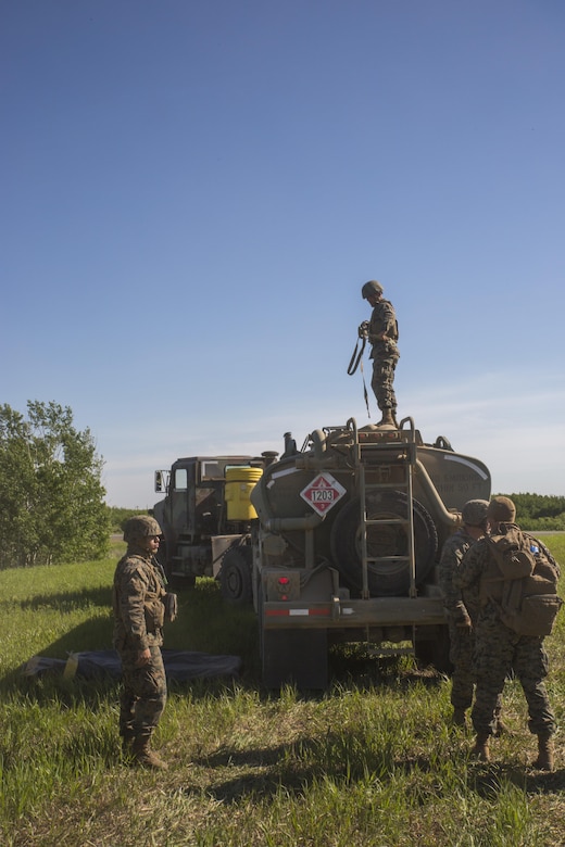 COLD LAKE, AB, CANADA -- Marines with Marine Wing Support Squadron 473, 4th Marine Aircraft Wing, Marine Forces Reserve, operate a forward arming and refueling point for Royal Canadian Air Force CH-147 Chinook and CH-146 Griffon type model series at the Canadian Manoeuvre Training Centre, Camp Wainwright in Alberta, Canada, May 30, 2017. Exercise Maple Flag prepares international aircrew, maintenance and support personnel for the rigours of operations in the modern aerial battlespace. (U.S. Marine Corps Photo by Lance Cpl. Niles Lee)