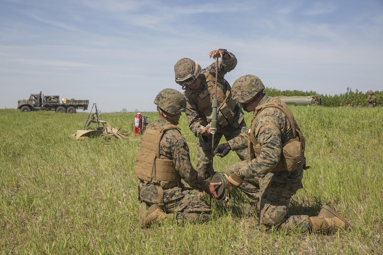 COLD LAKE, AB, CANADA – Cpl. Yasuey Gonzalez (left), Pfc. Robert Garcia (center), and Staff Sgt. Brian Beamer (right), bulk fuel specialists with Marine Wing Support Squadron 473, 4th Marine Aircraft Wing, Marine Forces Reserve, hammer a grounding rod into the earth at the Canadian Manoeuvre Training Centre during exercise Maple Flag 50, May 31, 2017. MWSS-473 is providing real world refueling support to Royal Canadian Air Force CH-147 Chinook and CH-146 Griffon type model series during exercise Maple Flag 50. (U.S. Marine Corps photo by Lance Cpl. Niles Lee/Released)