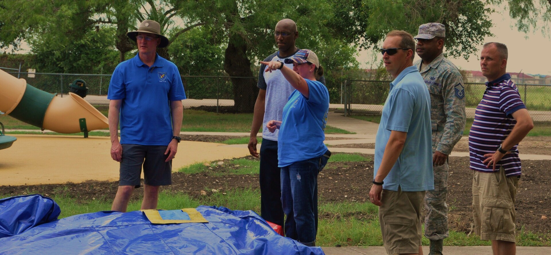 Col. Roger Suro (L), Maj. Thallas Lumpkin, Master Sgt. Sarah Cornelius, Lt. Col. Timonthy Chaman andMaster Sgt. Derrick Worthy discuss how to load the bouce house on the trailer after the family picnic following the 340 FTG MUTA held at Joint Base San Antonio-Randolph, Texas on June 8-9.  (Photo by Janis El Shabazz, 340 FTG Public Affairs).