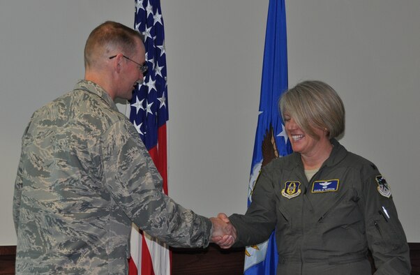 Col. Roger Suro, 340 Flying Training Group Commander, coins Lt. Col. Charlan Poirson at Joint Base San Antonio-Randolph, Texas.  Poirson was celebrated during the unit's MUTA, June 8-9 in recognition of her being named to the Key Personnel List and for her service as the Group’s Deputy Commander. She will soon depart for a new position working for Brig. Gen. Ellen Moore at the Air Reserve Personnel Center. (Photo by Janis El Shabazz, 340 FTG Public Affairs).