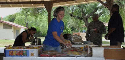 Maj. Teresa Davies, 340 Flying Training Group Deputy Chief, Plans and Programs (foreground), samples goodies at the Group's picnic after the unit's spring MUTA at Joint Base San Antonio, Texas, June 8-9. Other Citizen Airmen sampling the delights are (L-R) Maj. Joya Gamara, 340 FTG Executive Officer, Master Sgt. Joe Jimenez and Anthony Smith. (Photo by Janis El Shabazz, 340 FTG Public Affairs)